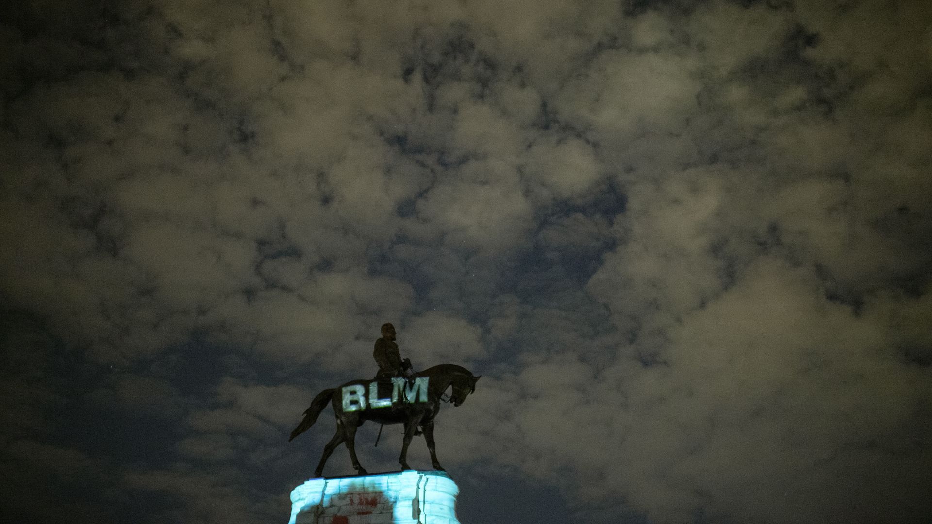 Night time scene as the letters for "Black Lives Matter" are projected onto the Robert E. Lee Statue on Monument Avenue in Richmond, VA on June 18, 2020