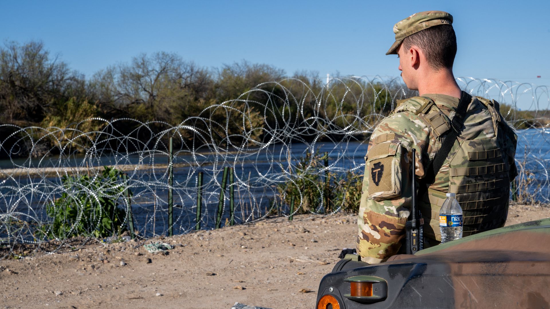 A National Guard soldier stands guard on the banks of the Rio Grande river at Shelby Park on January 12, 2024 in Eagle Pass, Texas.