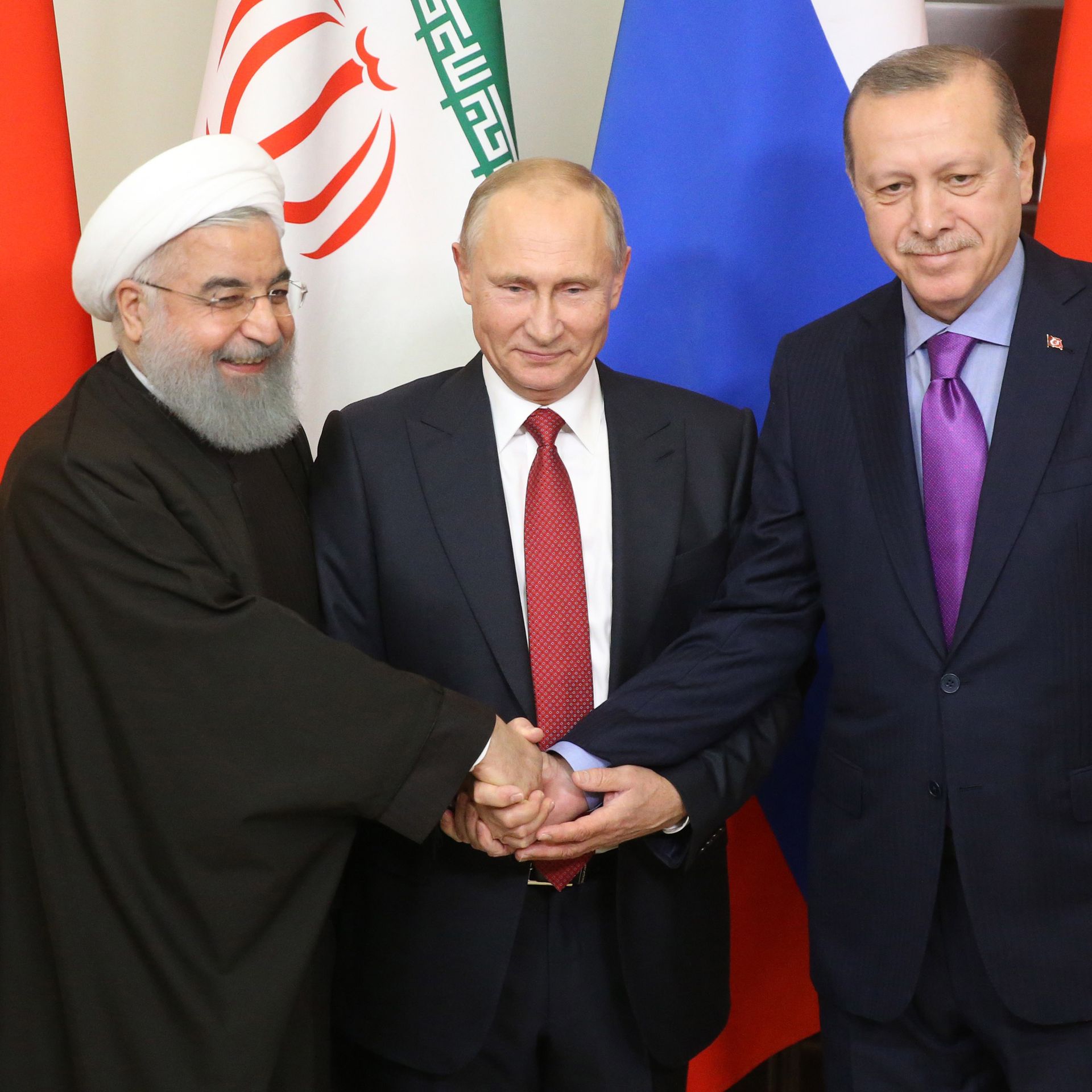 Russian President Vladimir Putin pose for a photo with Turkish President Recep Tayyip Erdogan and Iranian President Hassan Rouhani prior to their talks at Black Sea resort state residence