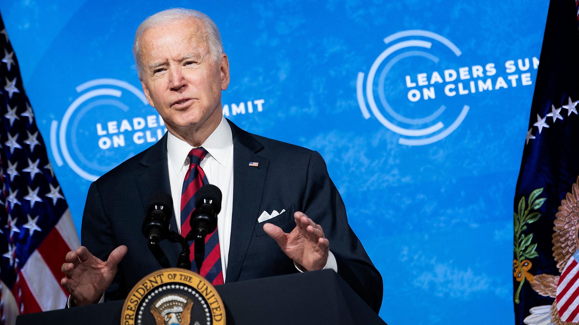 President Joe Biden speaks at a podium.