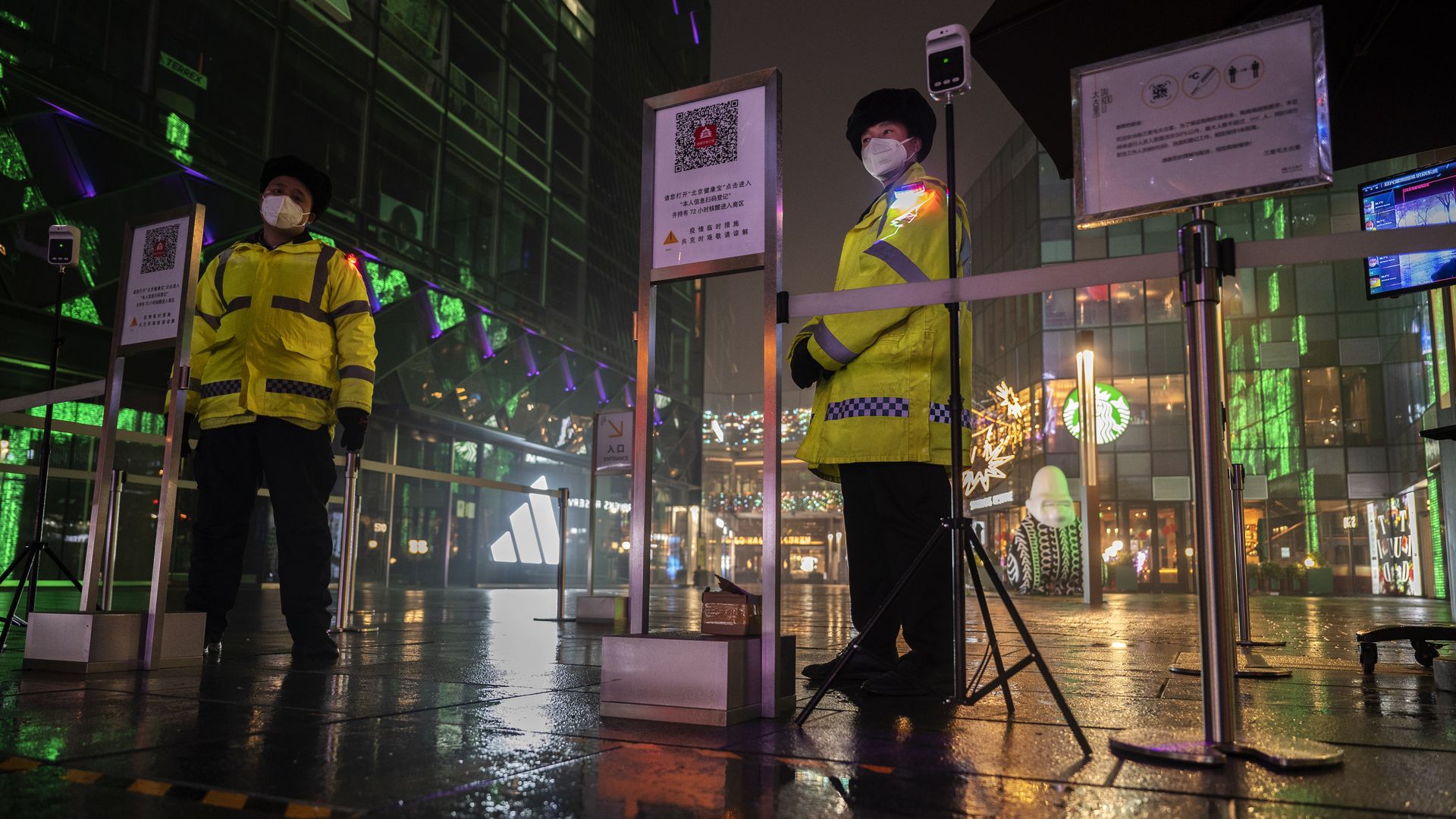 Security guards  standing outside a popular shopping district in Beijing on Nov. 20.