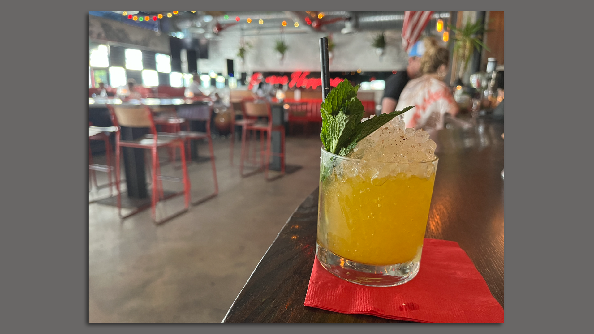 A whiskey smash from Sweet Liberty with a mound of crushed ice and mint leaves poking out.