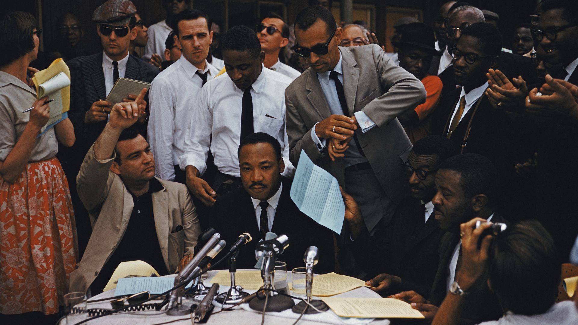 American clergyman and civil rights activist Martin Luther King Jr. sits at the center of a table at a press conference outside the A.G. Gaston Motel in Birmingham, Alabama, February 1963. Seated at the table (right) is civil rights leader Reverend Ralph Abernathy Sr.