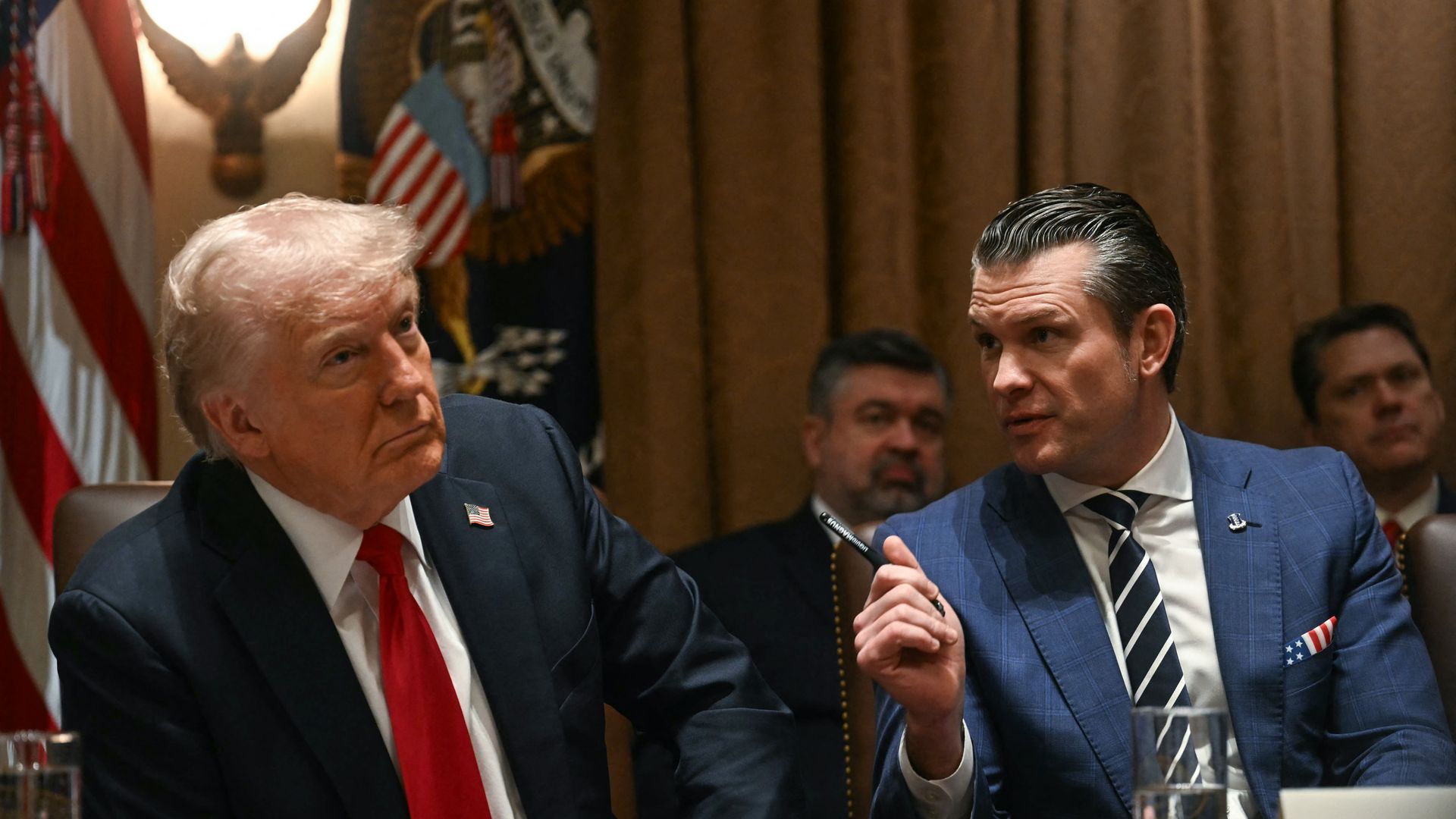 President Donald Trump looks on as Secretary of Defense Pete Hegseth speaks during a cabinet meeting at the White House in Washington, DC, on February 26, 2025.