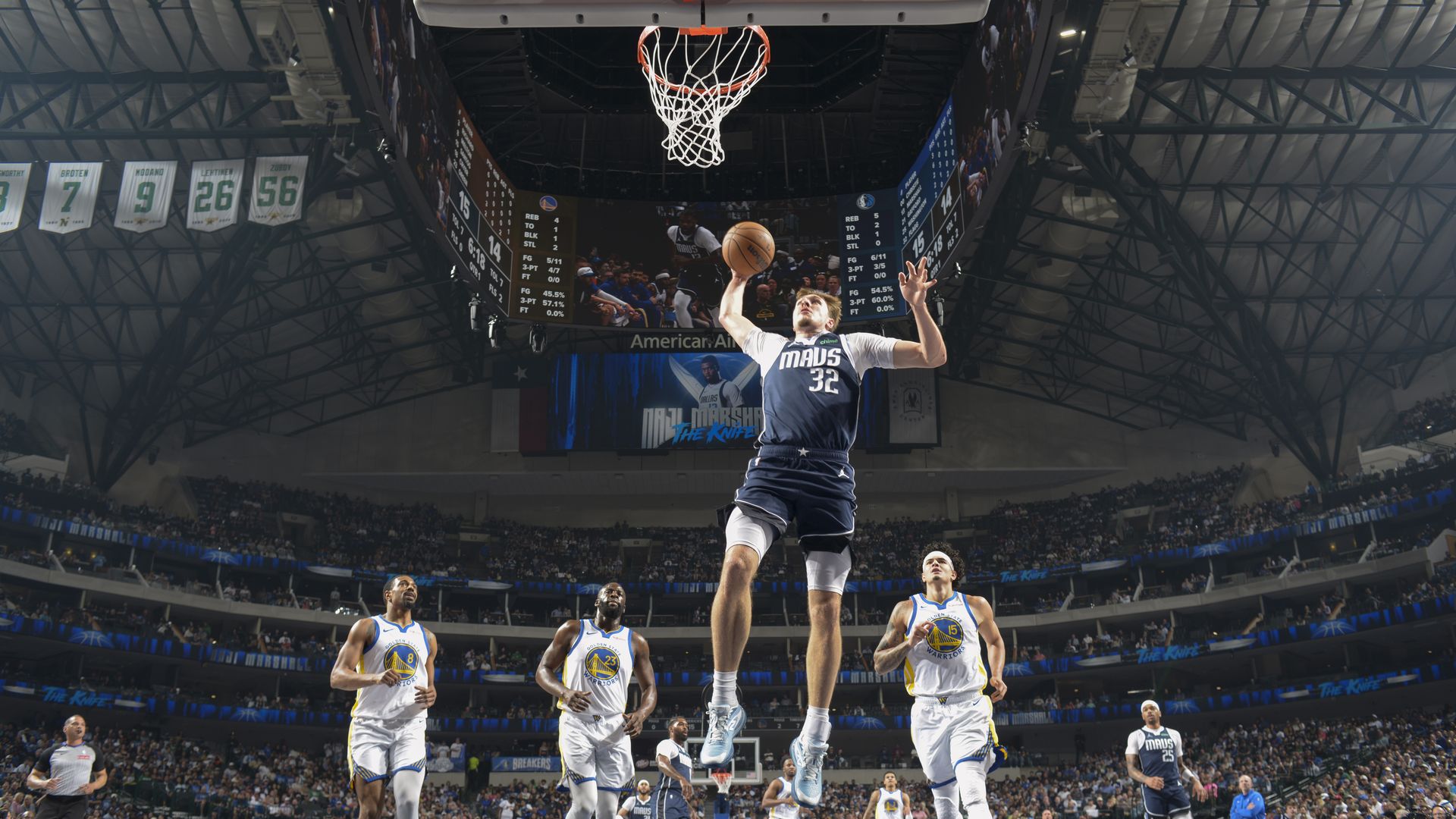 Cooper Flagg leaps in the air to made a basket during a game.