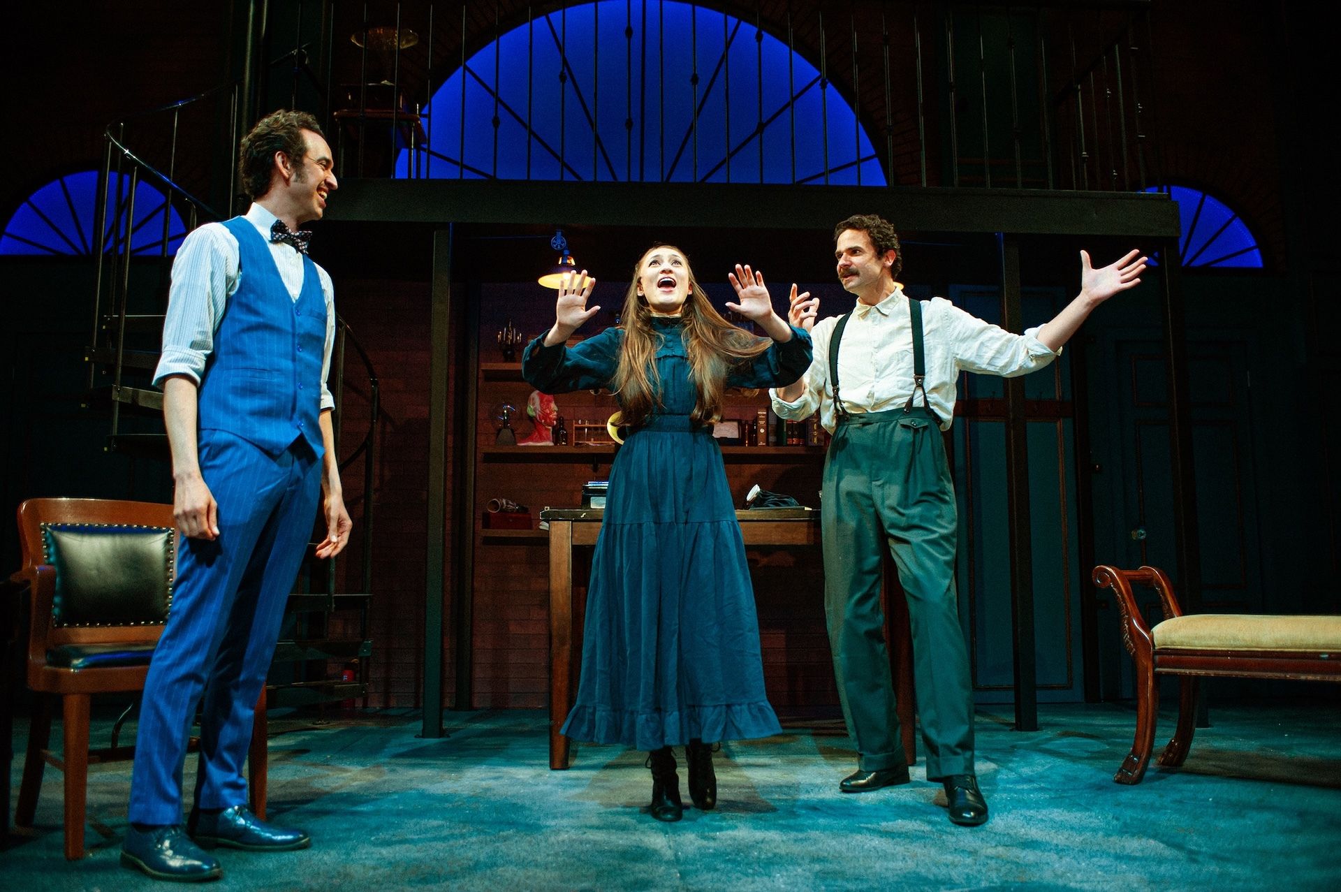 Photo of three performers on stage in period costume