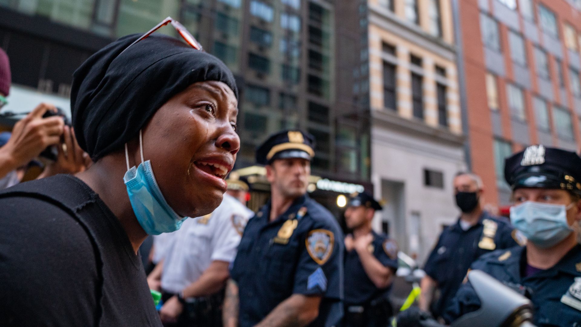 A woman is seen crying in New York City as protesters and law enforcement continue to clash following George Floyd's death on May 30, 2020. 