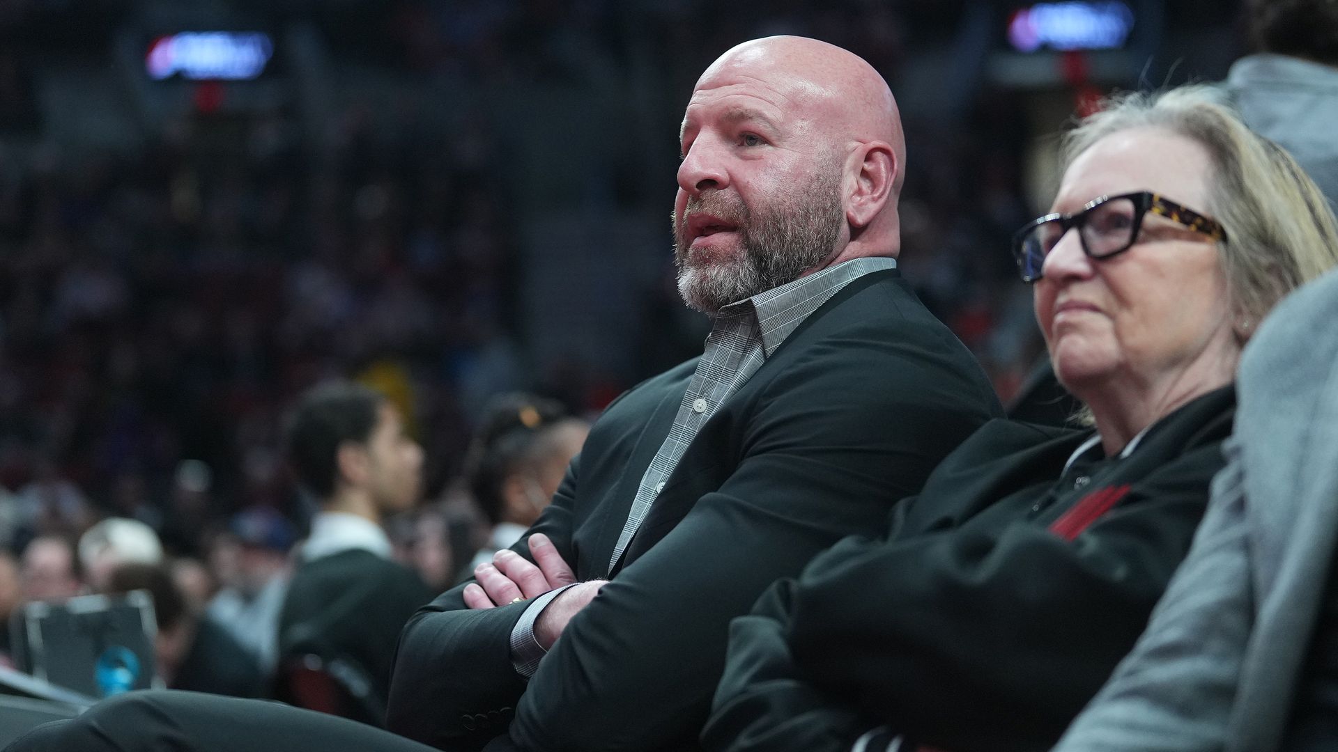 Portland Trail Blazers general manager sits next to owner Jody Allen at an NBA game.