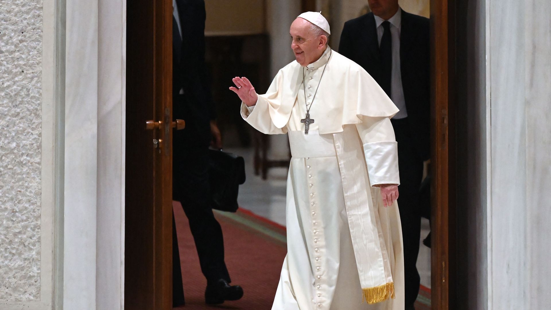 Pope Francis walks in the Paul VI hall as he arrives for his weekly general audience on August 18, 2021 in the Vatican