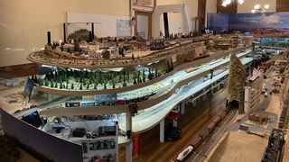 A four-story model train set on a landscape depicting various parts of Arizona