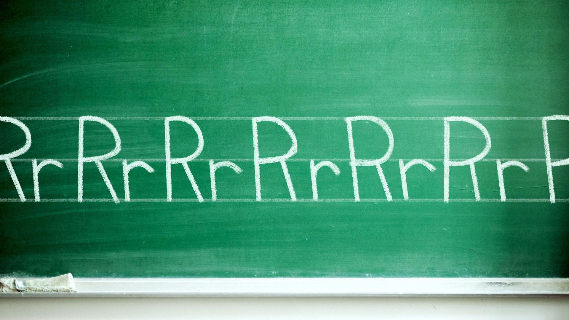 A chalkboard with capitalized and lowercase R's.