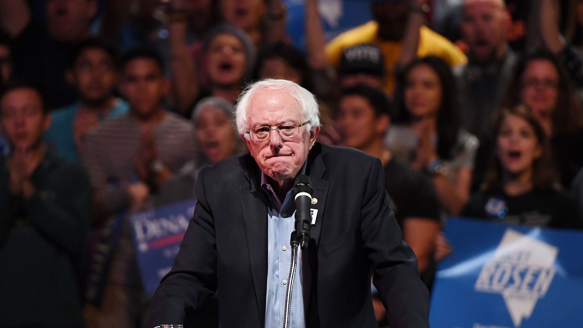 Bernie Sanders hunched over a podium.