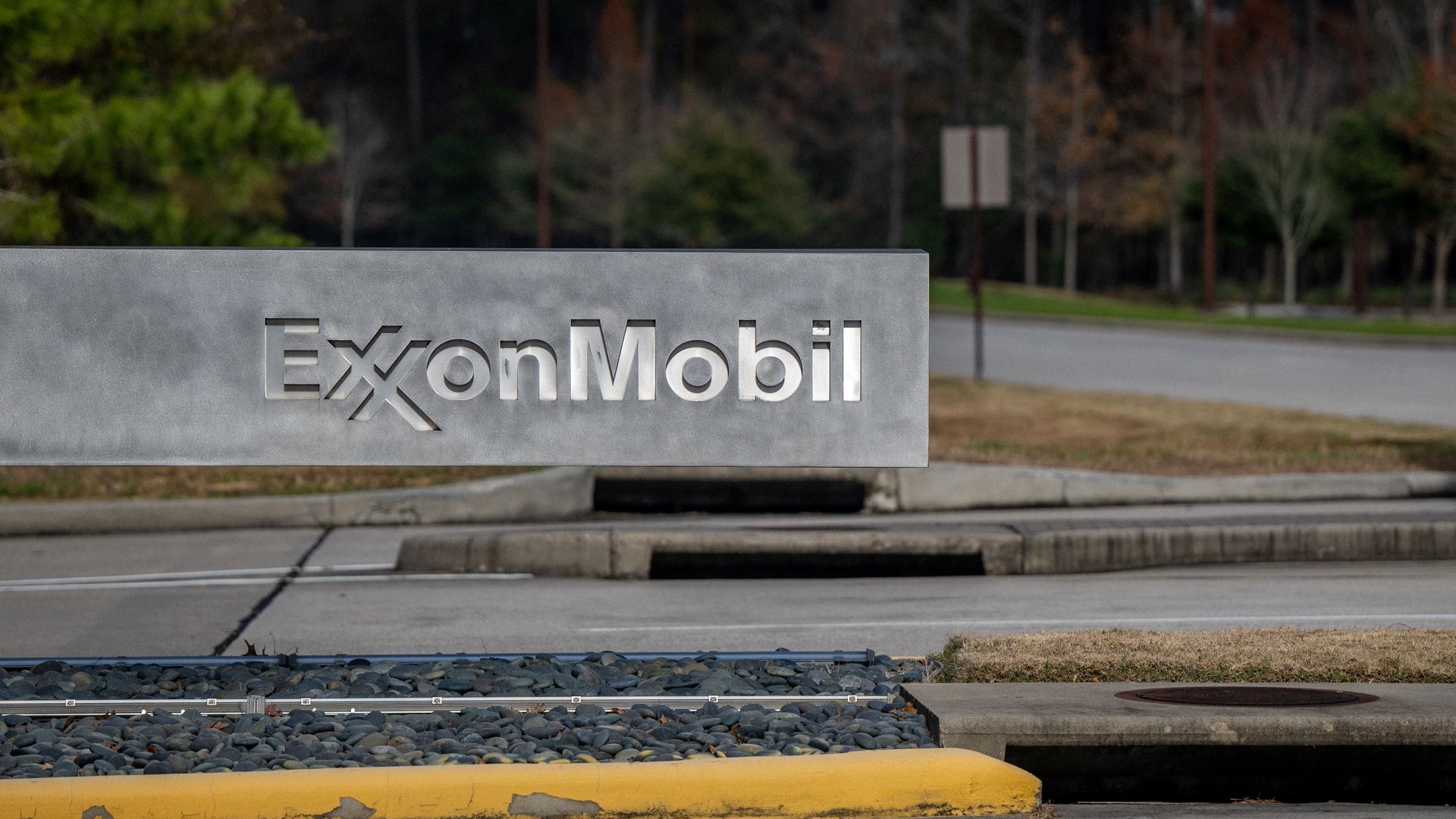 Photo of a gray stone sign with the ExxonMobil logo etched into it