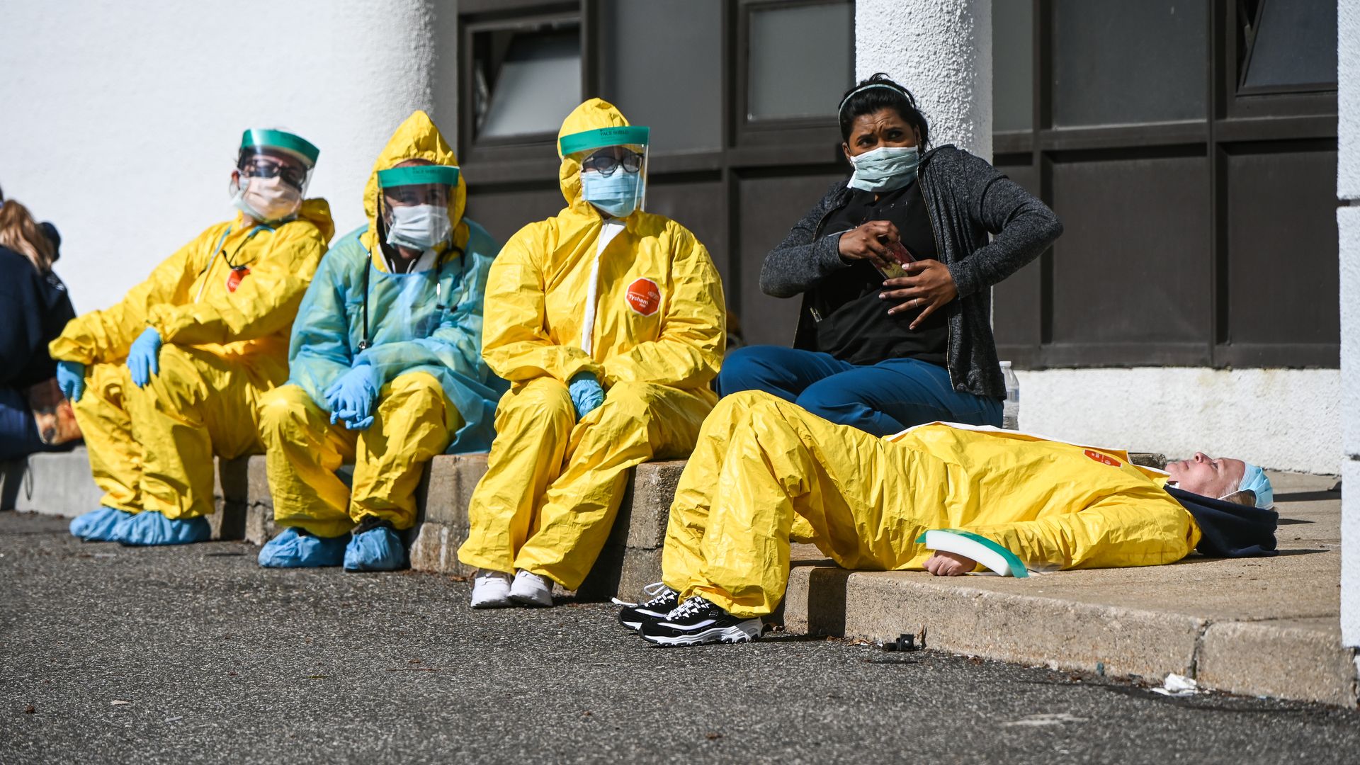 Health care workers in hazmat suits.