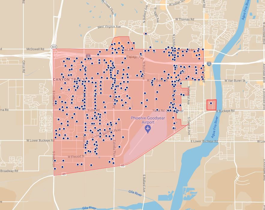 A city map with a zone that's shaded in light red and filled with several hundred small blue dots.