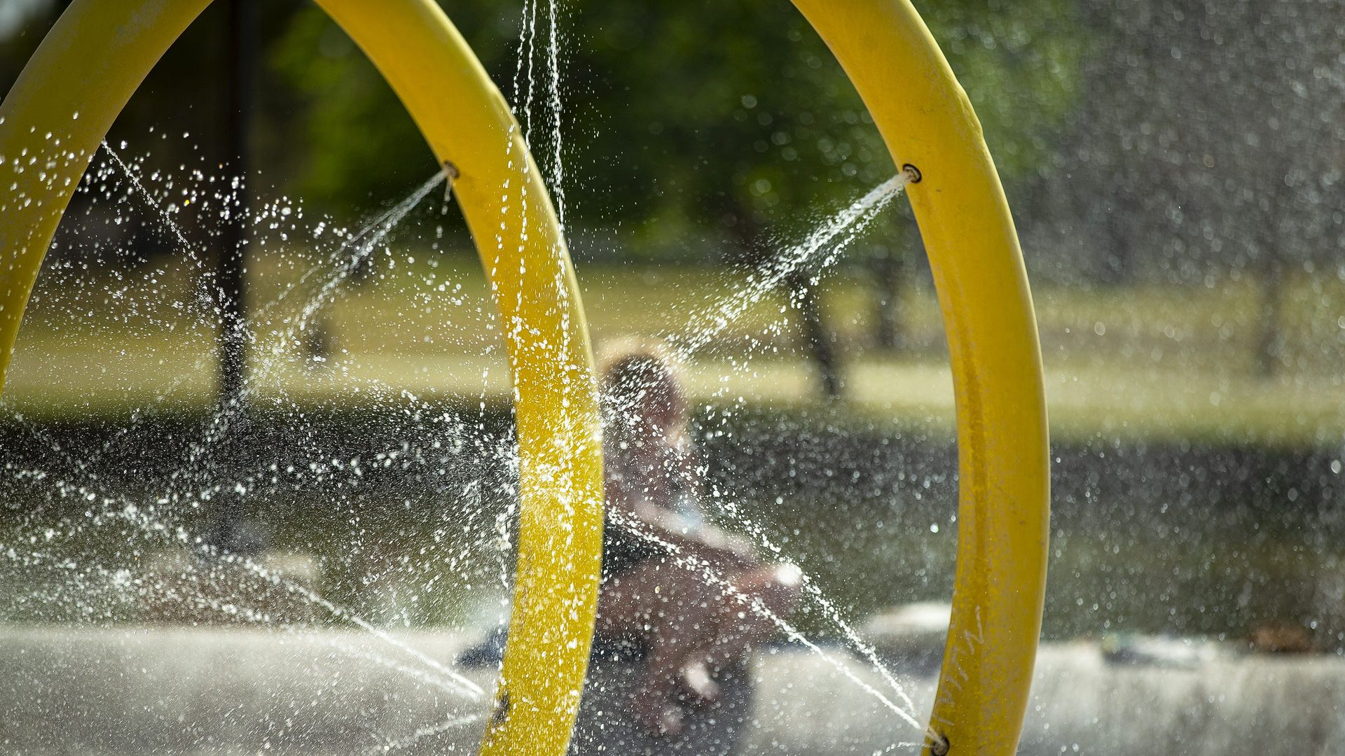 Water spraying from metal hoops at a splash pad in the Phoenix area