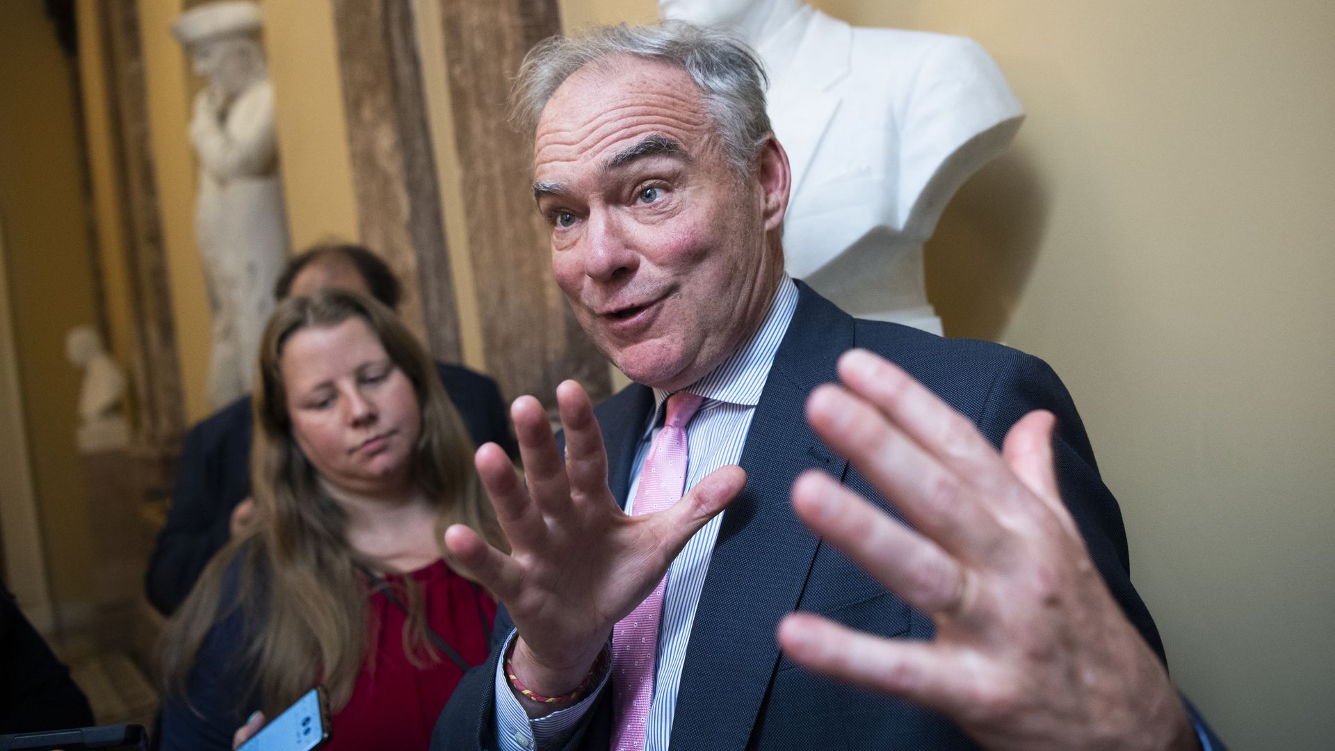 Sen. Tim Kaine is seen speaking with reporters.