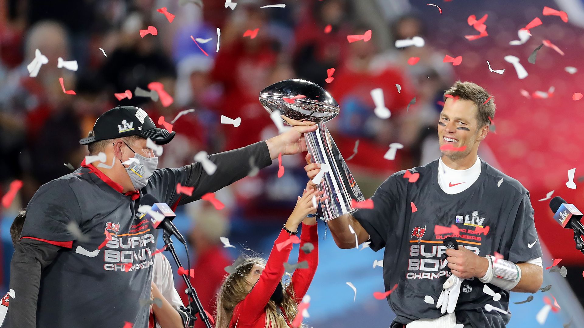 Tom Brady receives the Lombardi Trophy as confetti falls after the Tampa Bay Buccaneers won Super Bowl LV in Tampa.