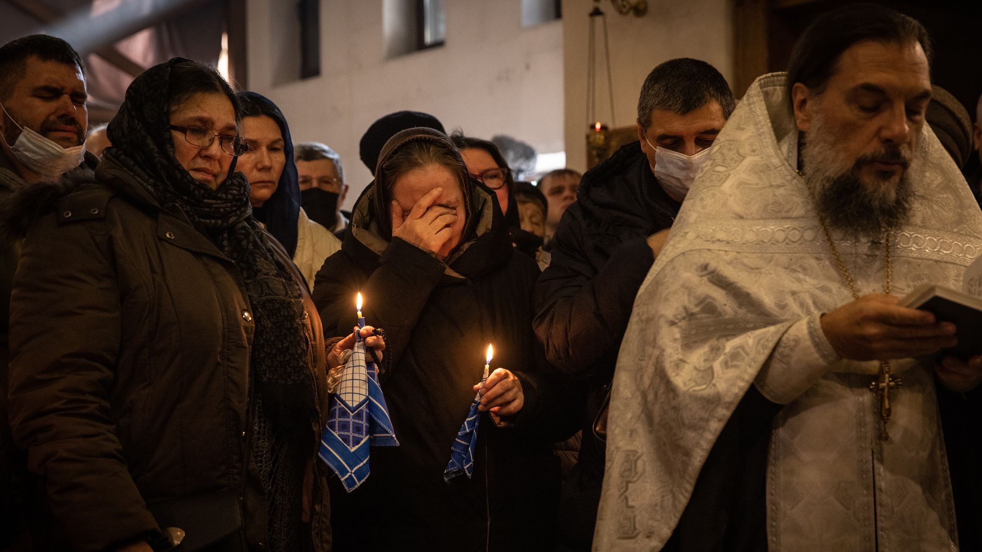 Mourners are seen during the funeral Tuesday for a Ukrainian soldier killed in recent fighting.