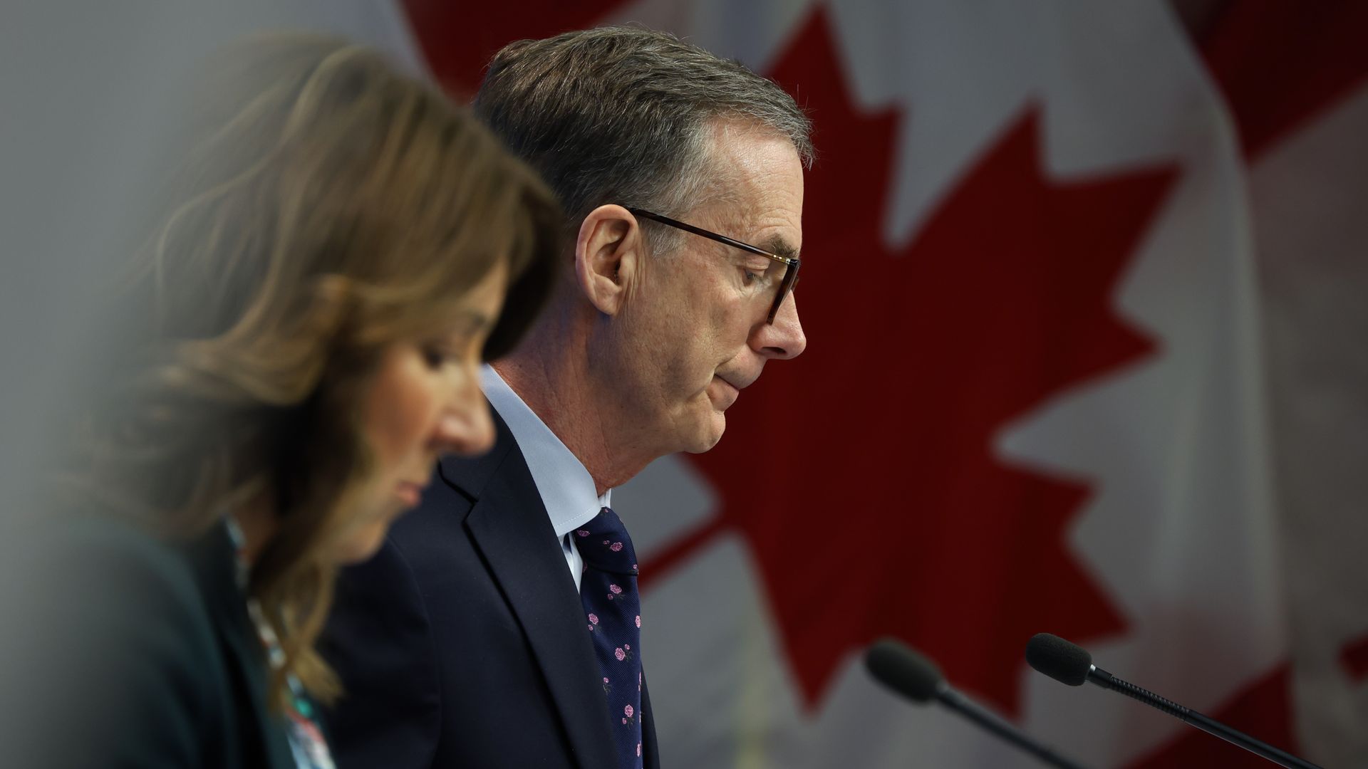 canada central bankers with canadian flag in the background