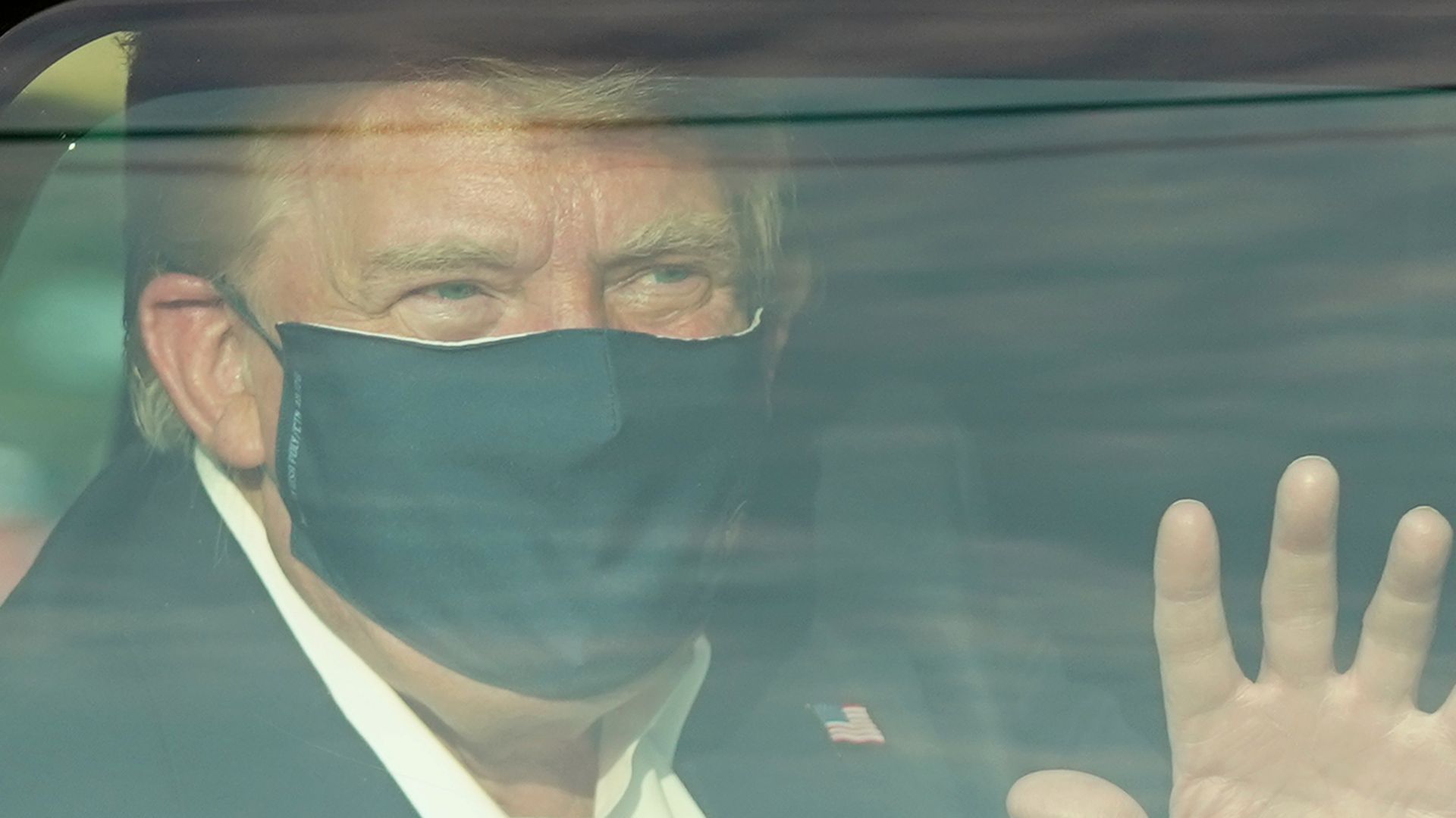 President Trump drives past supporters in a motorcade outside of Walter Reed Medical Center in Bethesda, Maryland on October 4