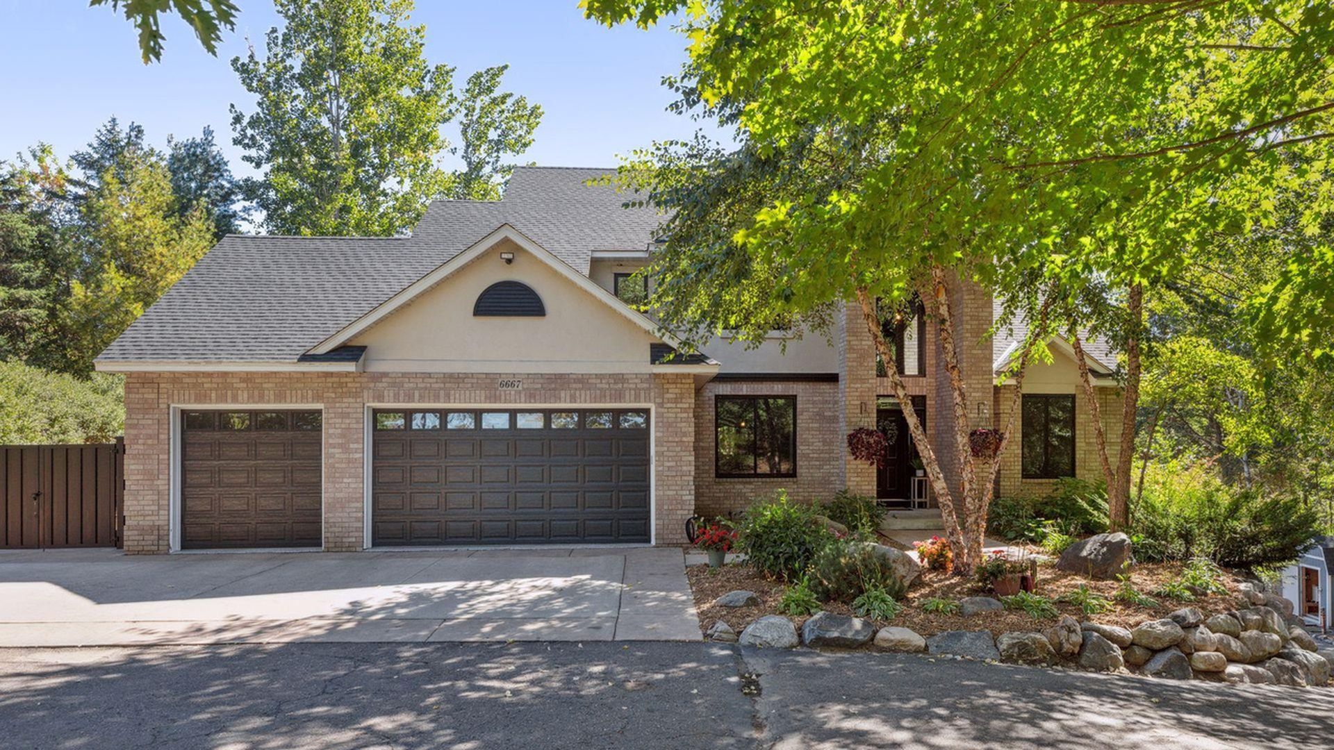 brick and stone house tucked among the trees