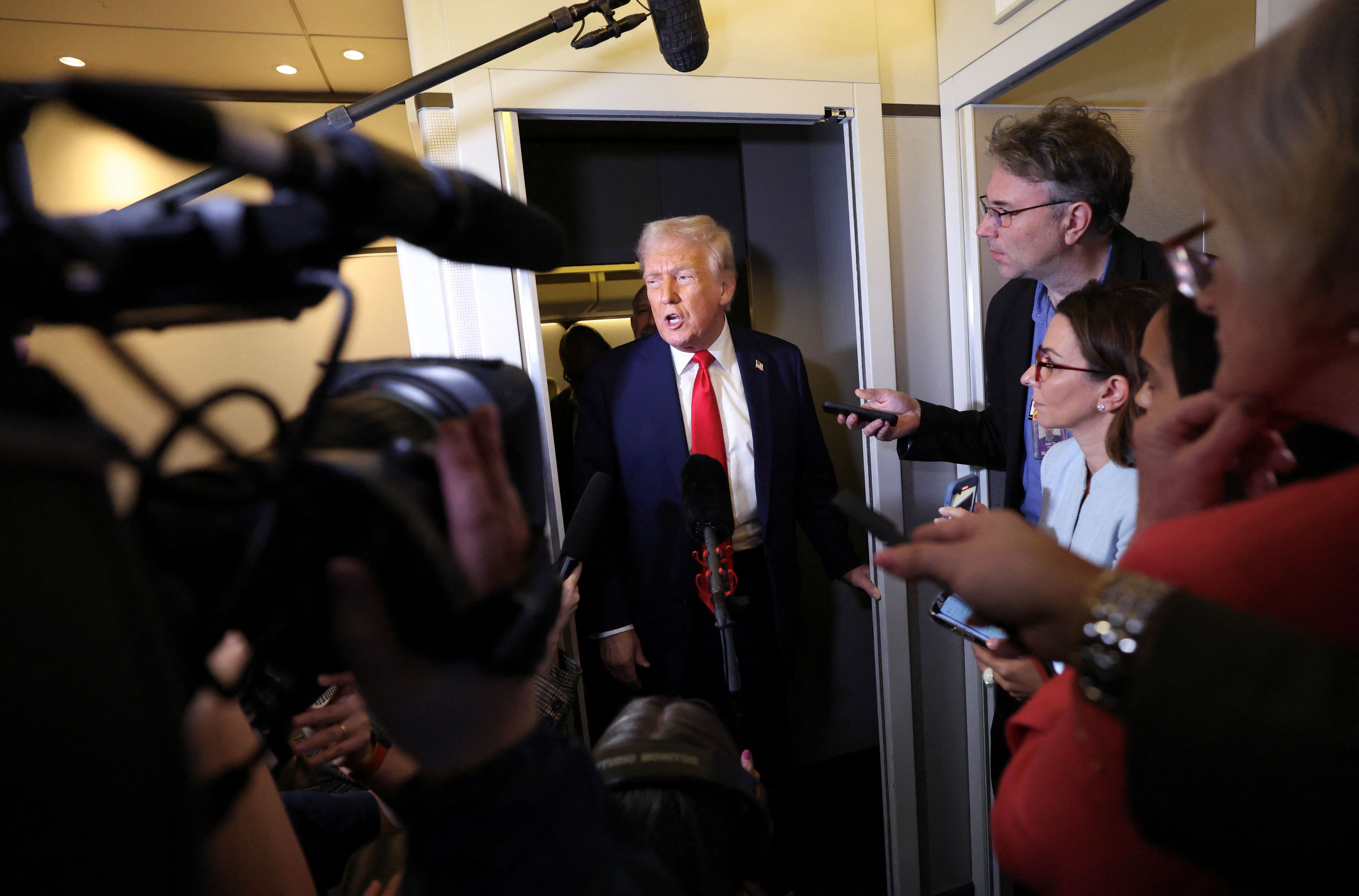 President Trump speaks to reporters on Air Force One while flying from Palm Beach to D.C. last night.