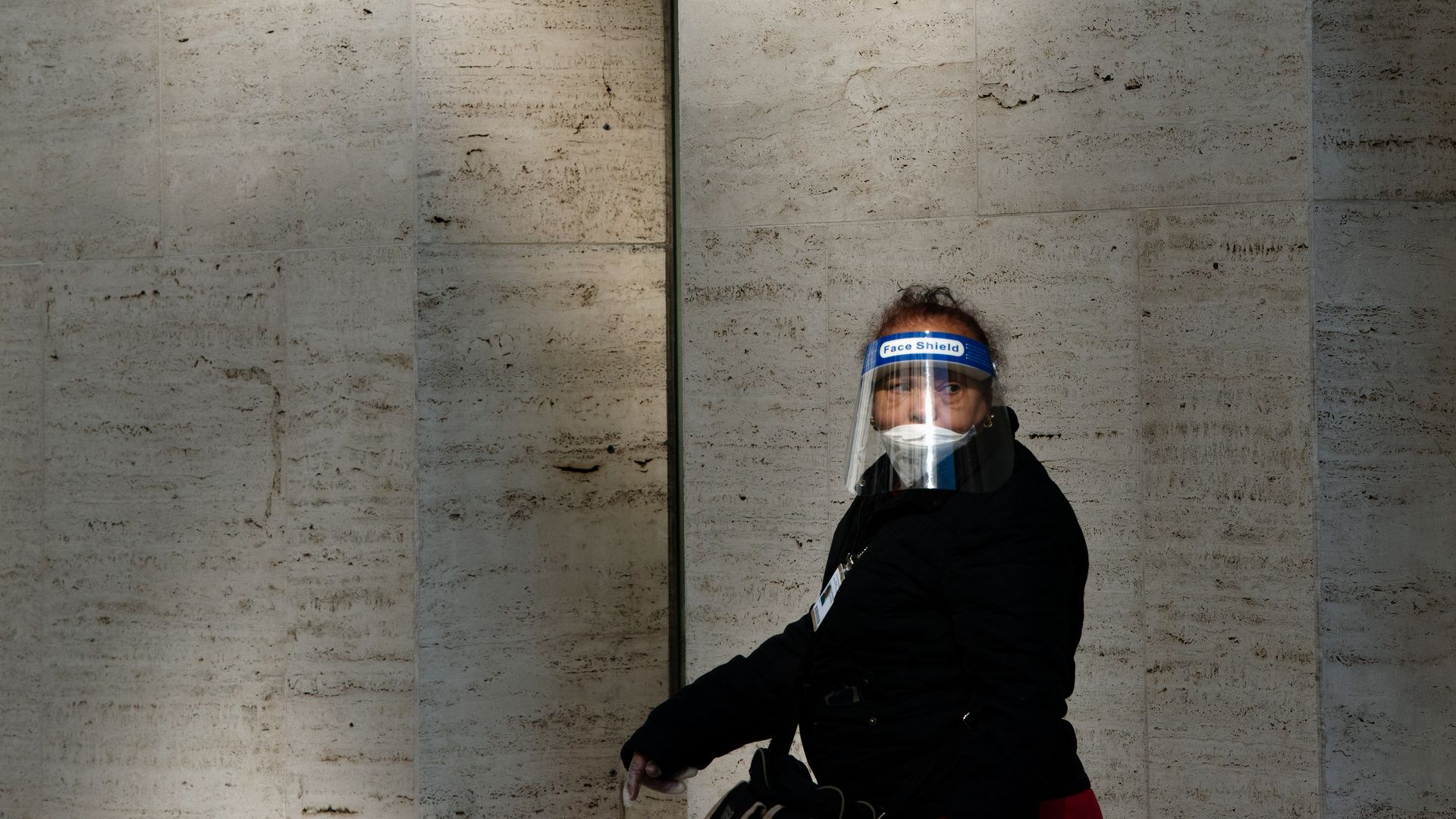 In this image, a woman wears a face shield