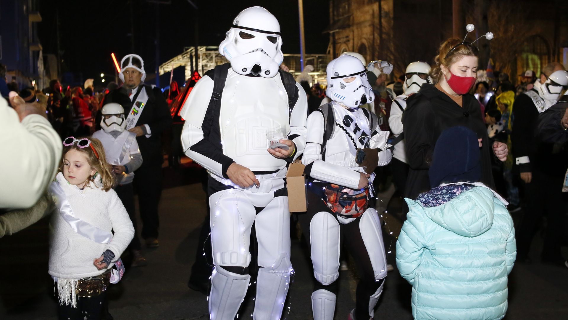 Chewbacchus parade marchers dressed as storm troopers from "Star Wars" walk a parade route.