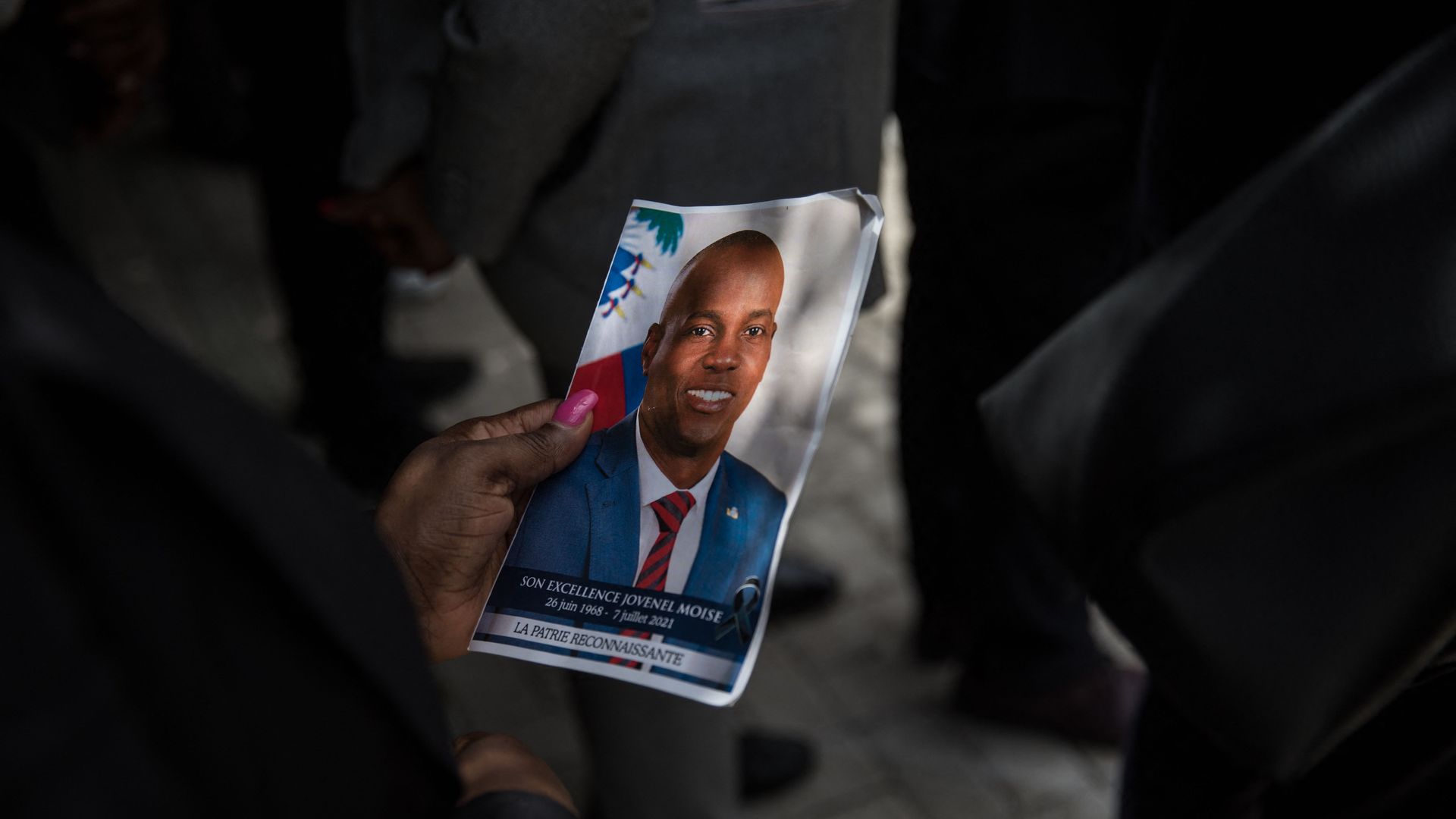 A guest holds a picture of late Haitian President Jovenel Moise during a ceremony at the National Pantheon Museum in Port-au-Prince, Haiti, on July 20, 2021.