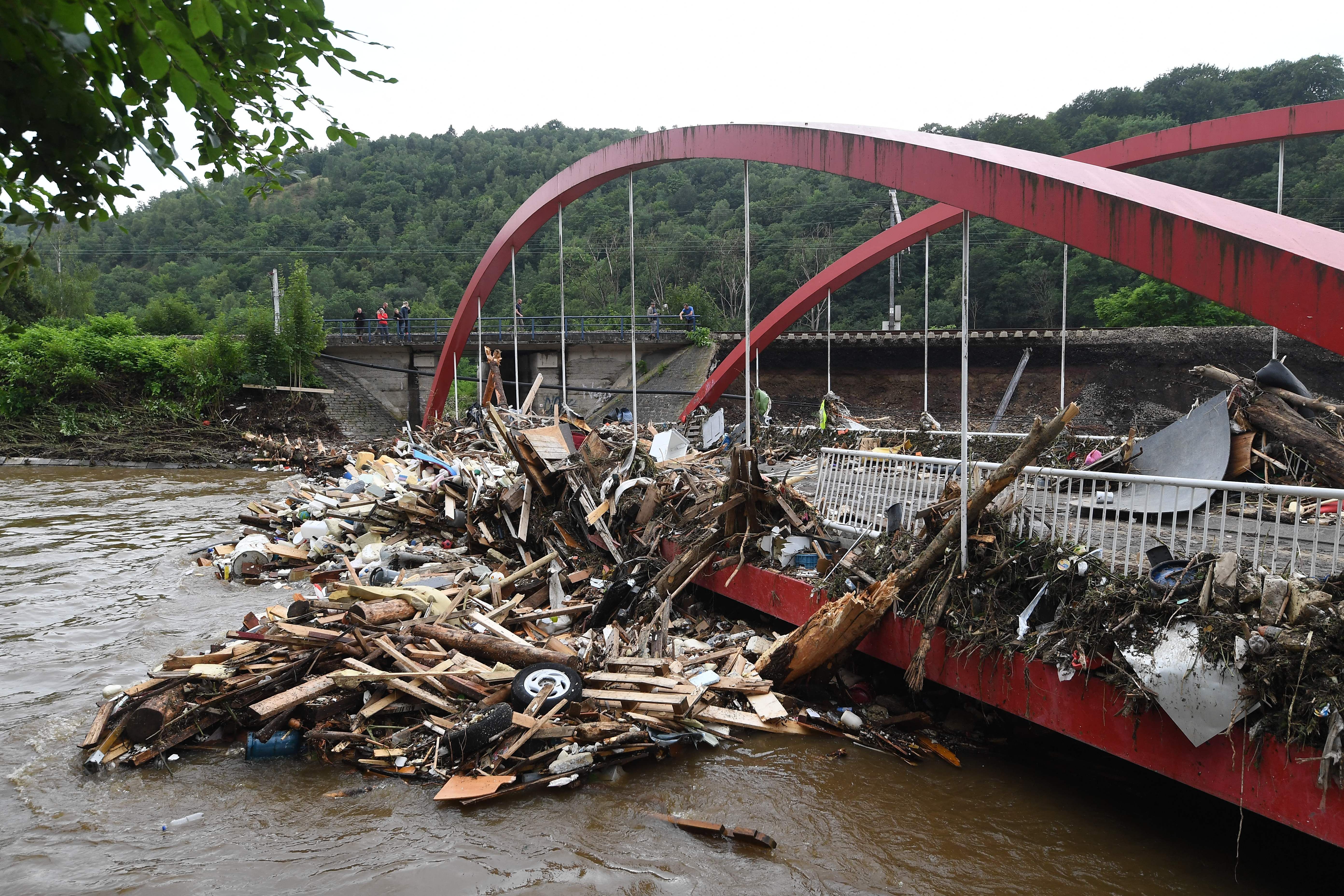 This picture taken in Chaudfontaine, near Liege, on July 16, 2021 shows debris piled up next to a bridge after the flood. 