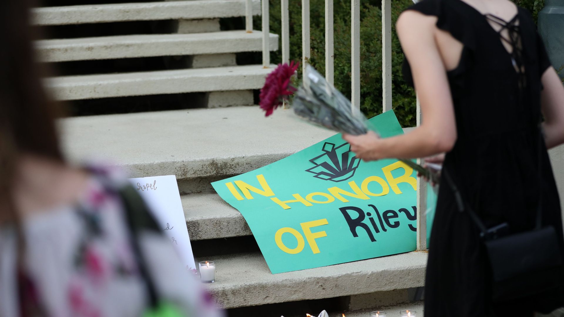 Students lay candles and flowers at the steps of Kennedy Hall to honor the victims of a shooting the day earlier at the University of North Carolina Charlotte, in Charlotte, North Carolina.