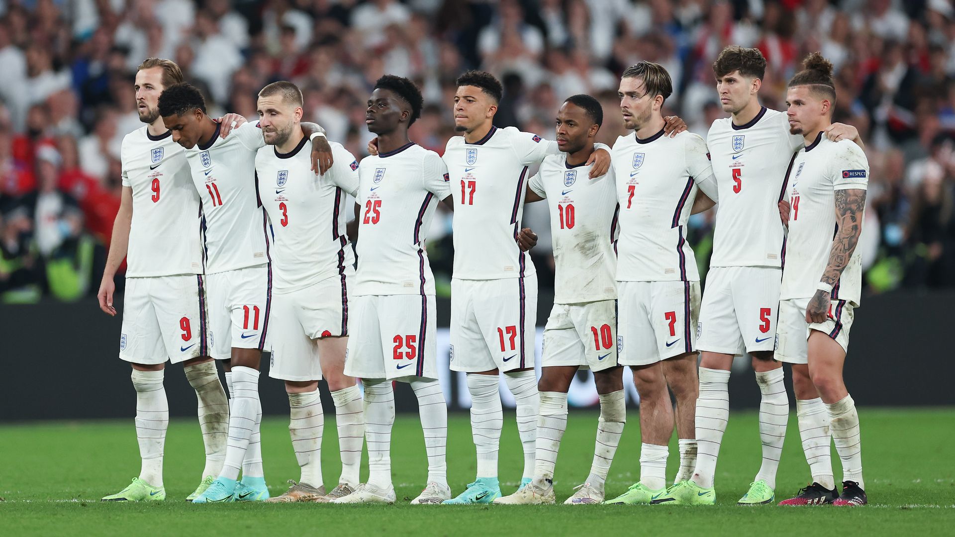 The England players look on from the half way line during a penalty shoot out at the UEFA Euro Championship Final between Italy and England at Wembley Stadium on July 11, 2021 in London, England