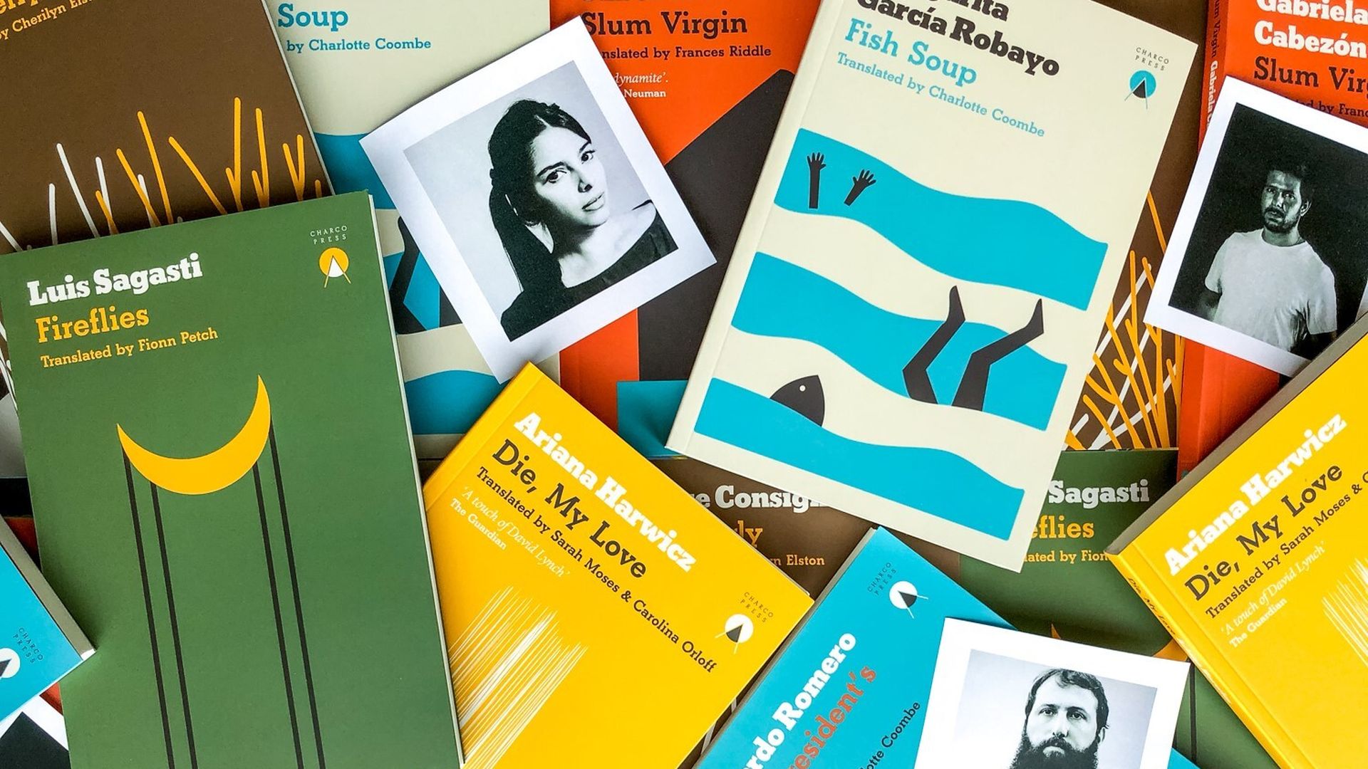 Several books in different colors like green, yellow, blue and brown are scattered