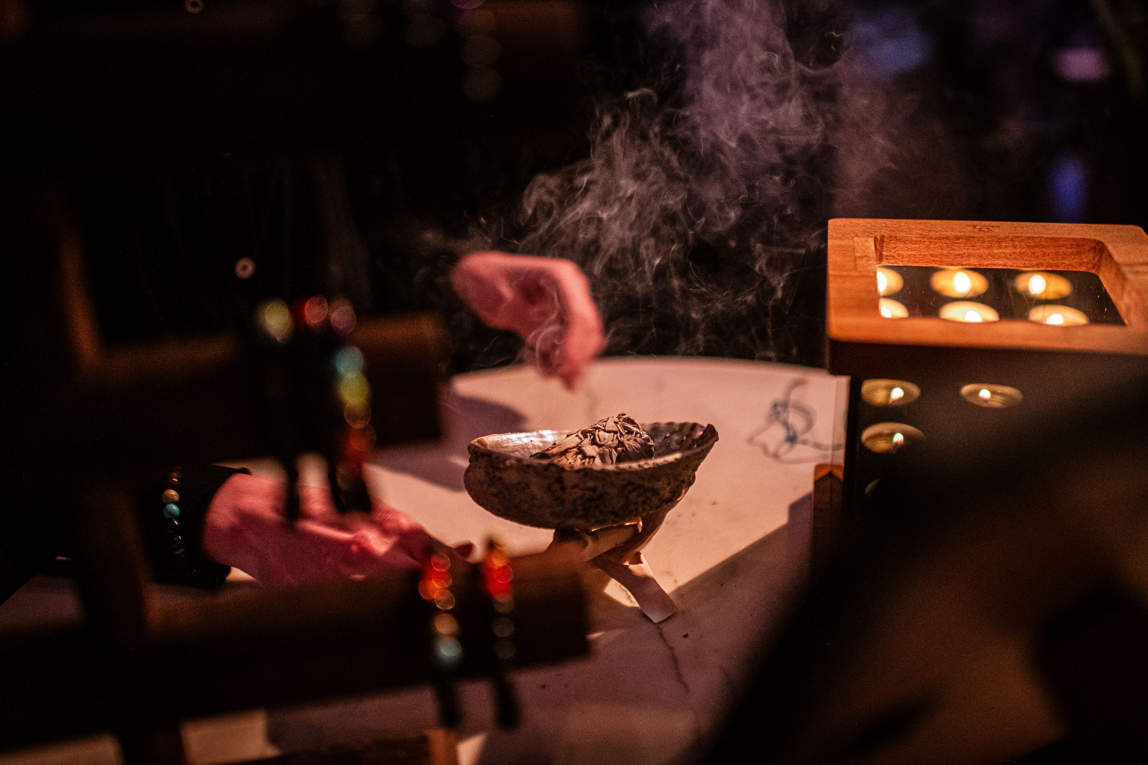 A smoking shell is held in two hands