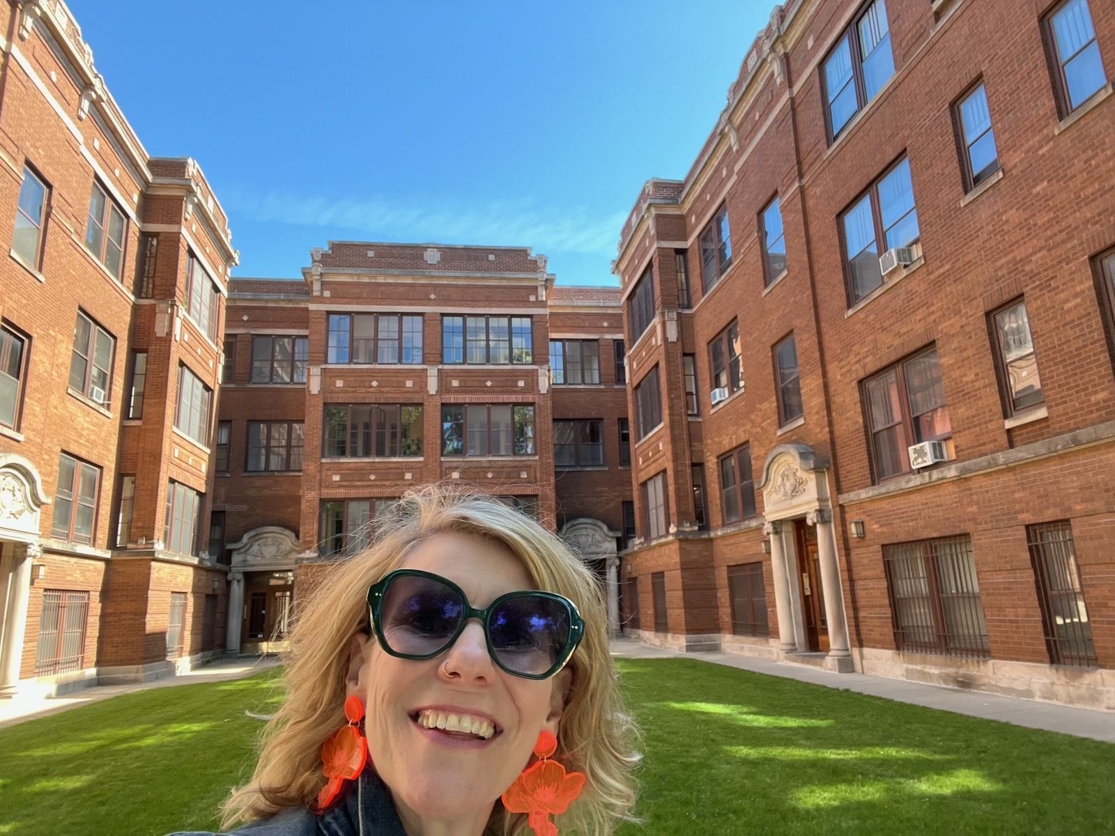 Photo of a woman standing in front of an apartment building