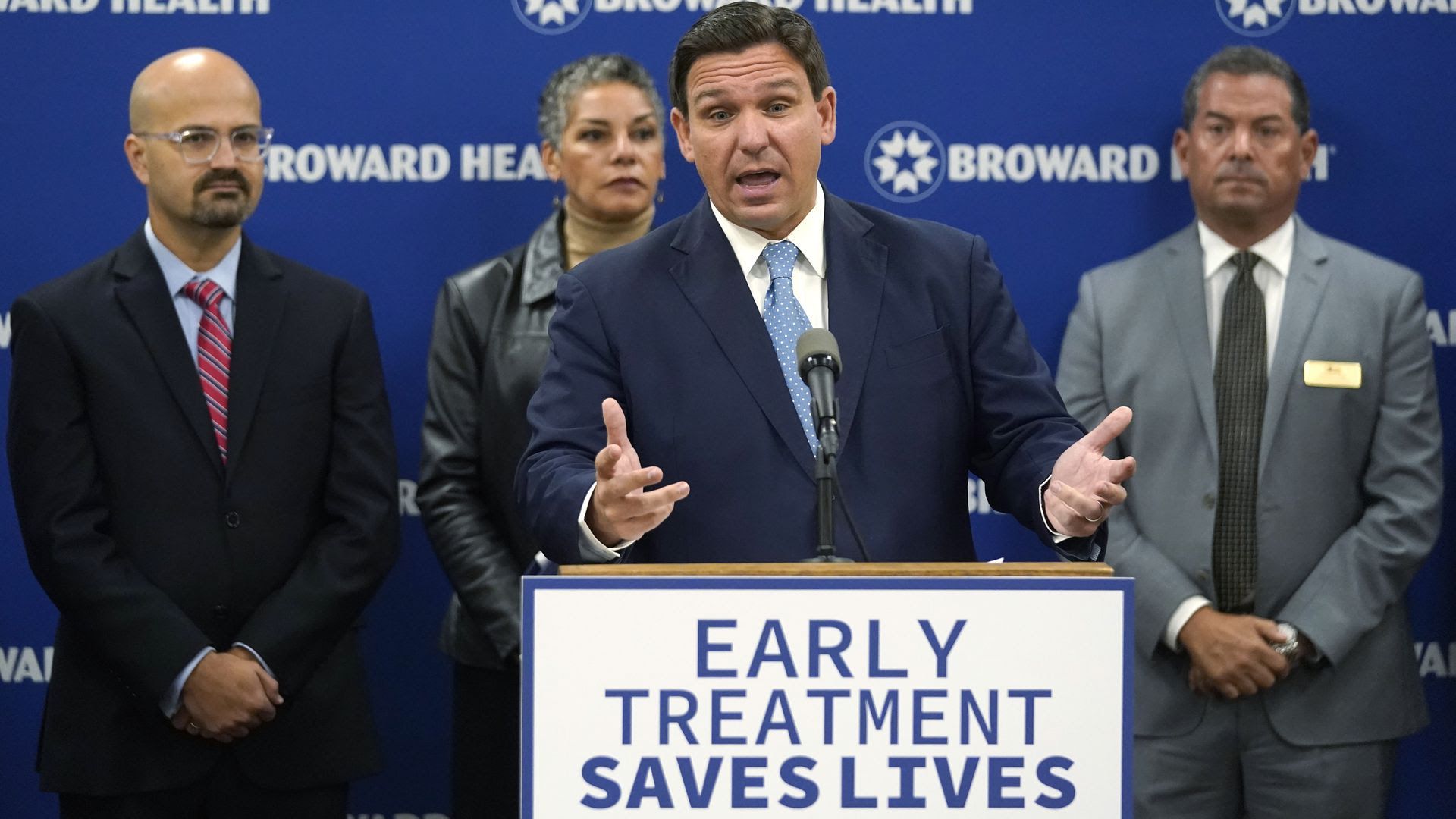 Gov. Ron DeSantis, center, speaks Monday at Broward Health Medical Center in Fort Lauderdale. 