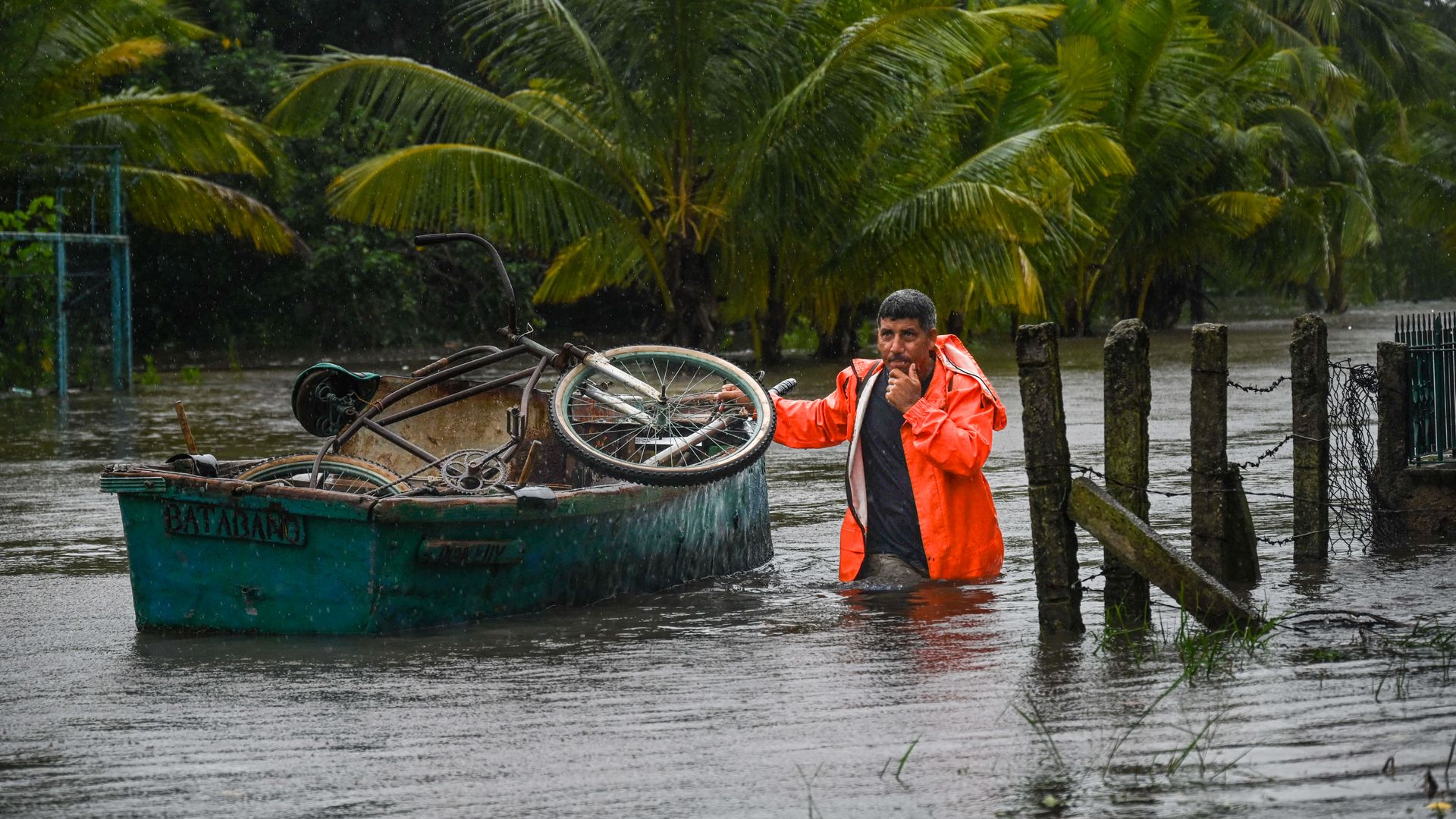 A resident of the coastal town of Guanimar in Artemisa province, southwest of Havana, transports his personal belongings in a boat on a flooded street after the passage of Hurricane Helene on September 25, 2024
