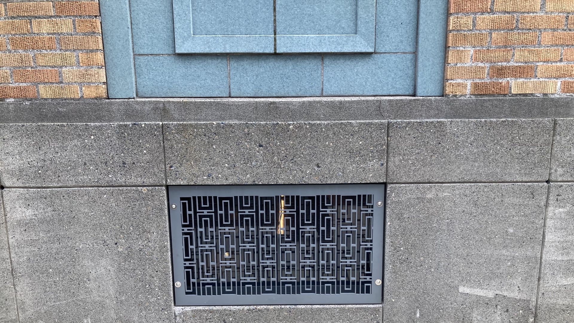 A grate and some stone work on an old building in Seattle.