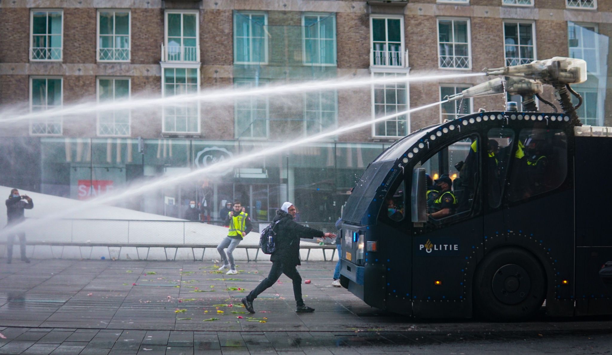 Photo of a truck spraying protesters with water cannon