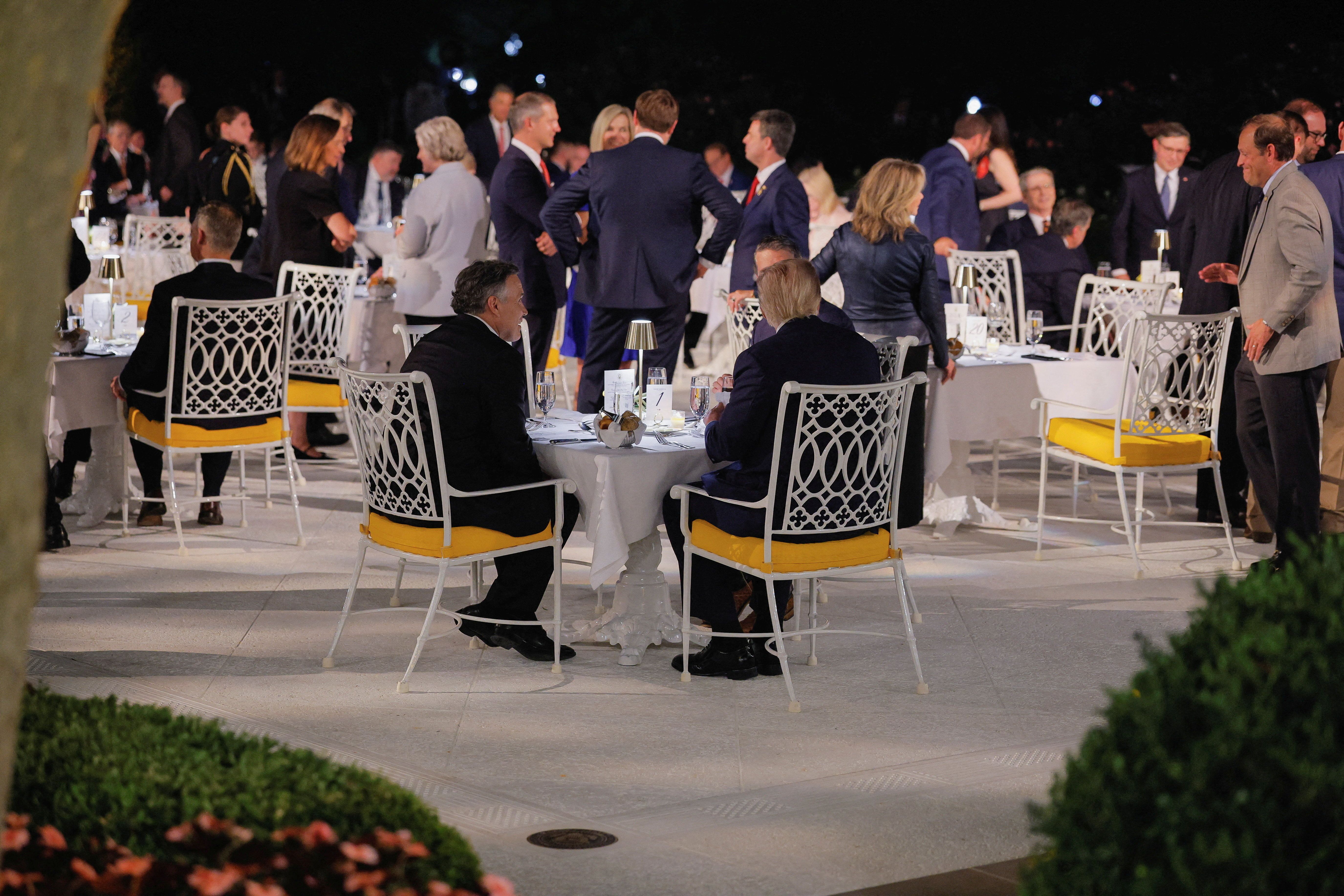 Recreating the aura of the Mar-a-Lago patio, President Trump visits with Sen. Dave McCormick (R-Pa.) and Rep. Ronny Jackson (R-Texas) during a Rose Garden Club dinner for lawmakers in September.
