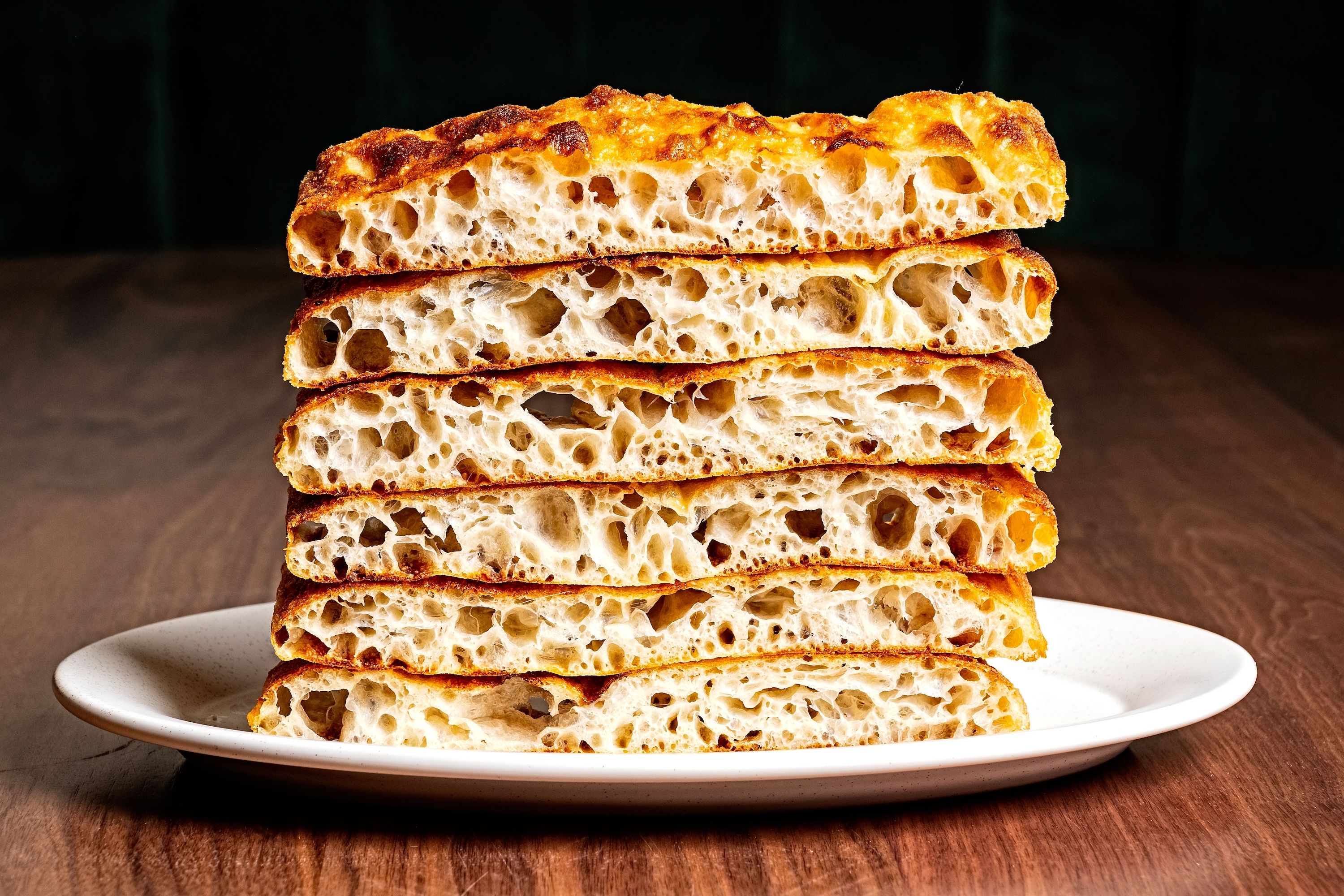 Focaccia stacked on a white plate 