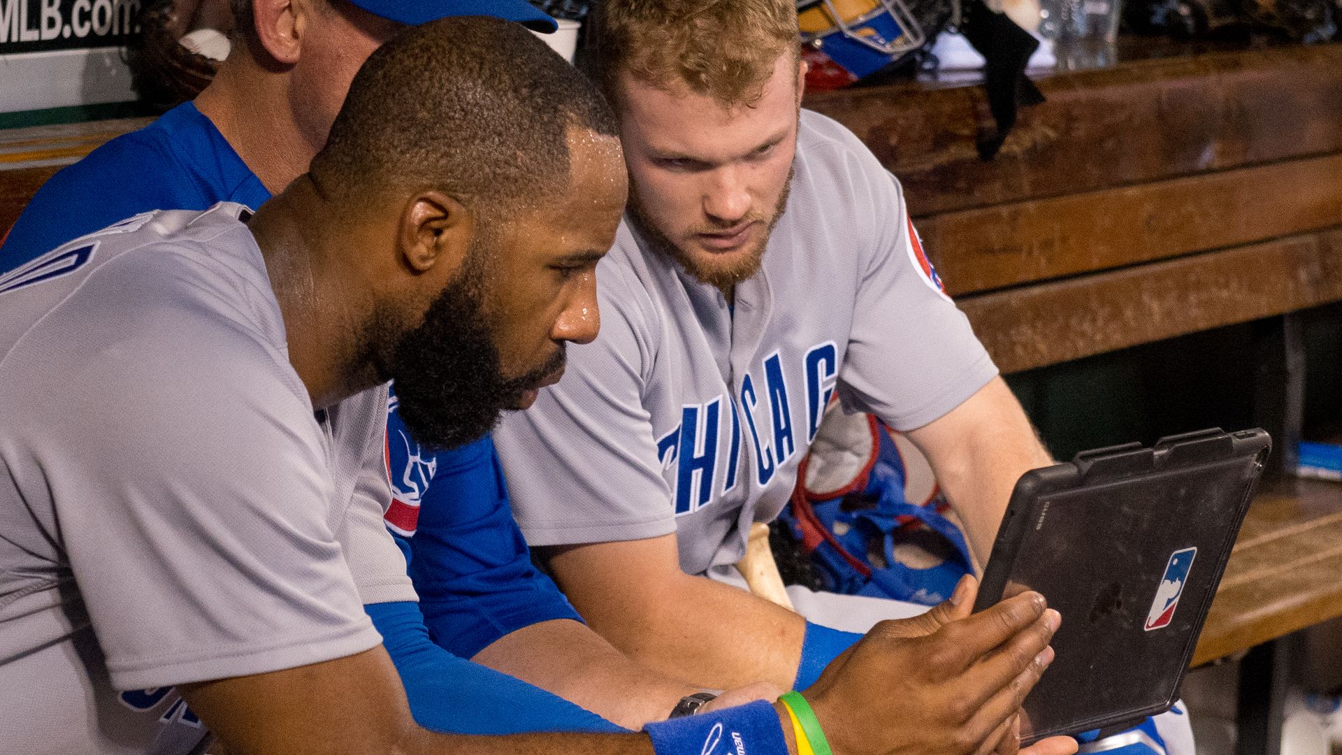Cubs players watching an iPad