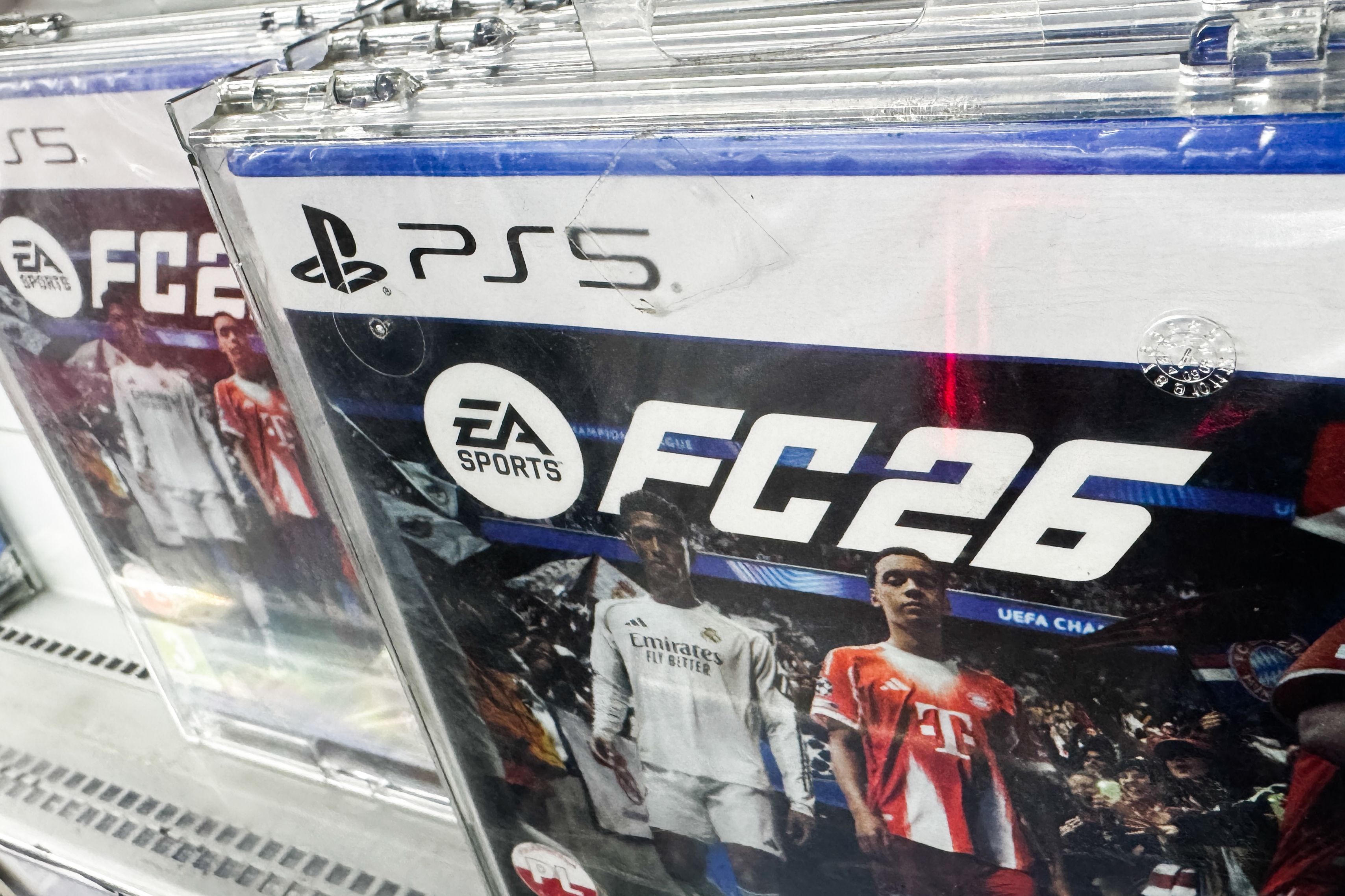 The EA Sports FC26 game is seen on a store shelf with two soccer players on the cover.

