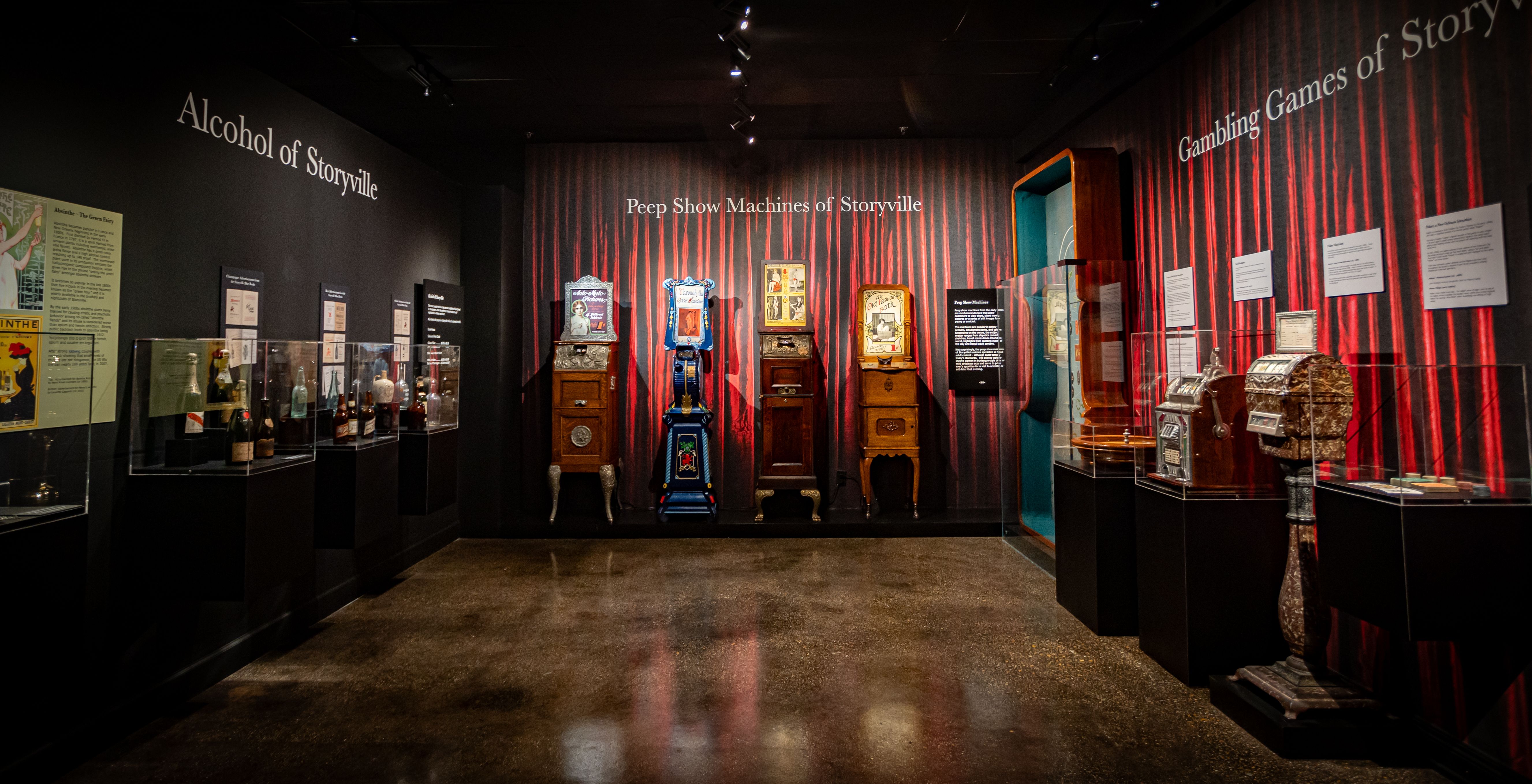 Three museum displays featuring gambling and peep show machines.