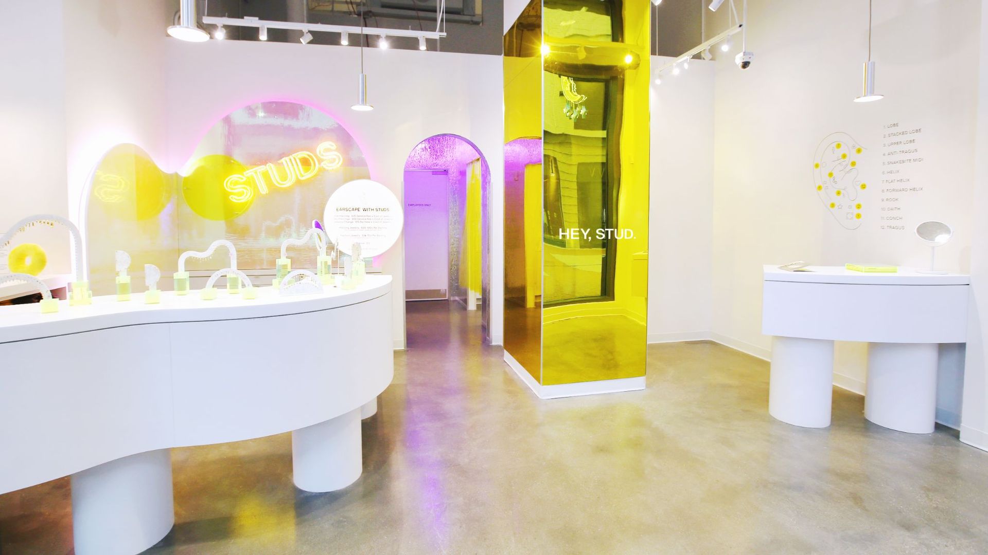 The white and yellow interior of a modern Studs jewelry studio