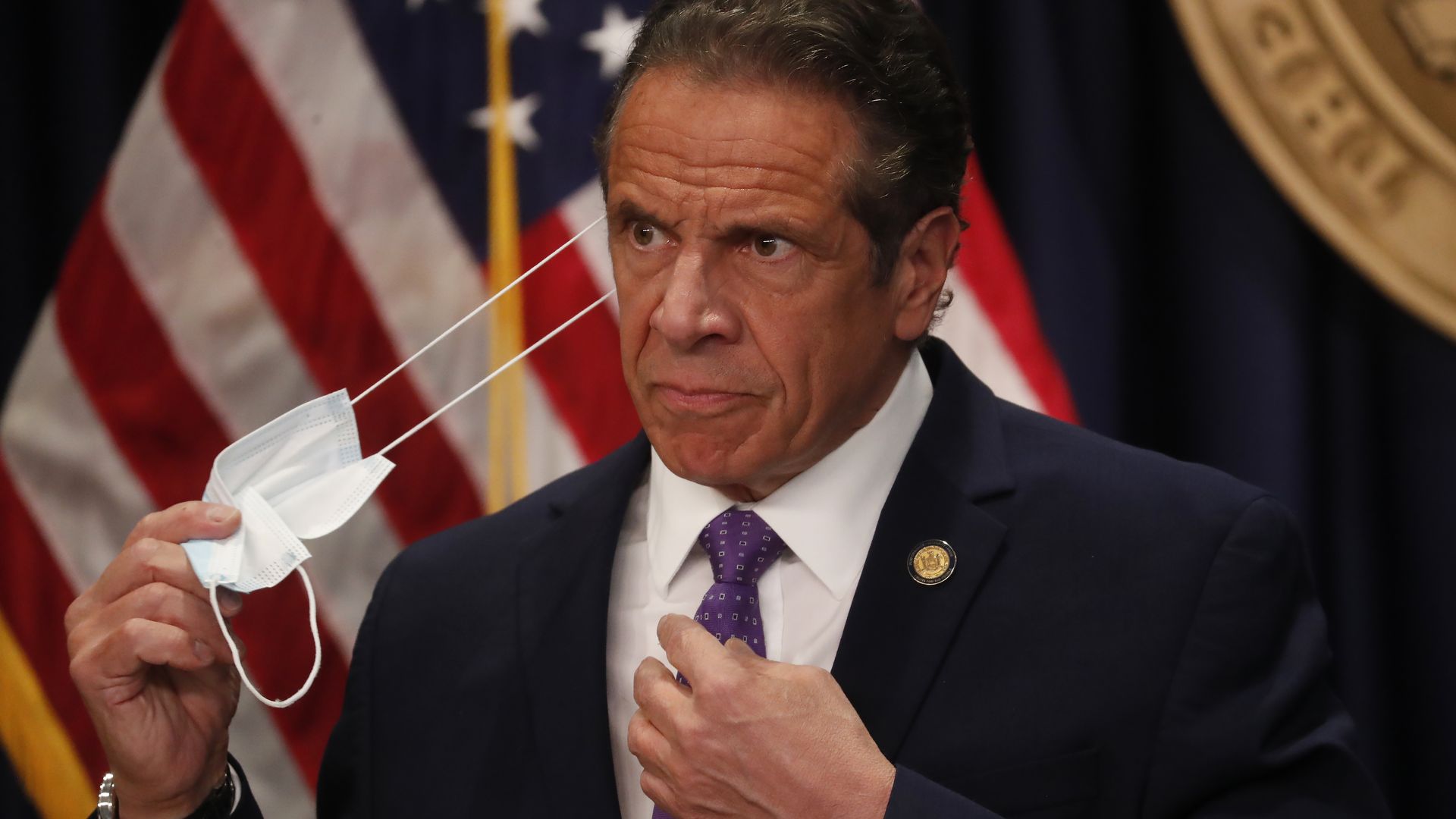 a photo of Cuomo removing a mask.
