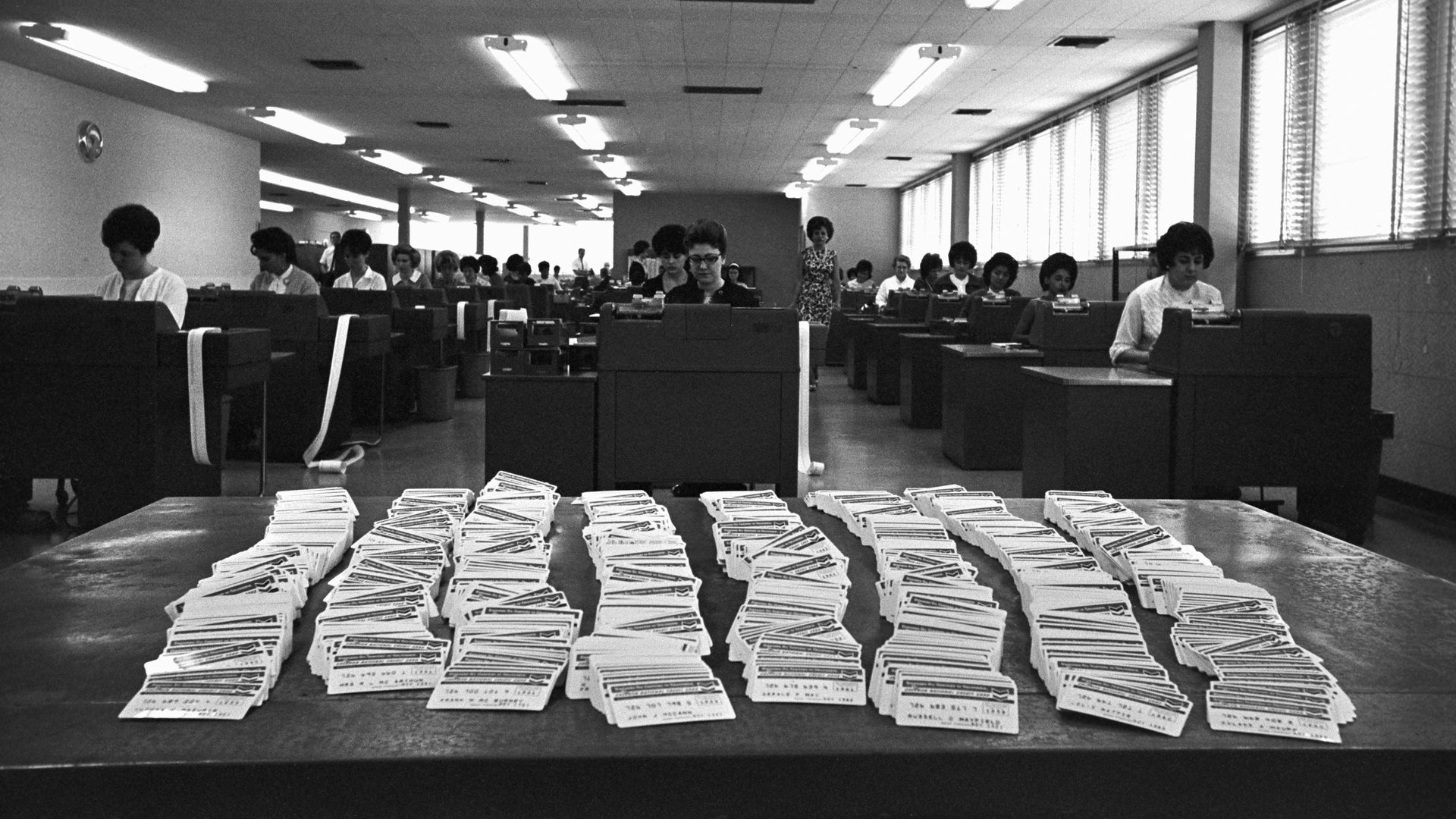 A table piled with credit cards in a black and white photo