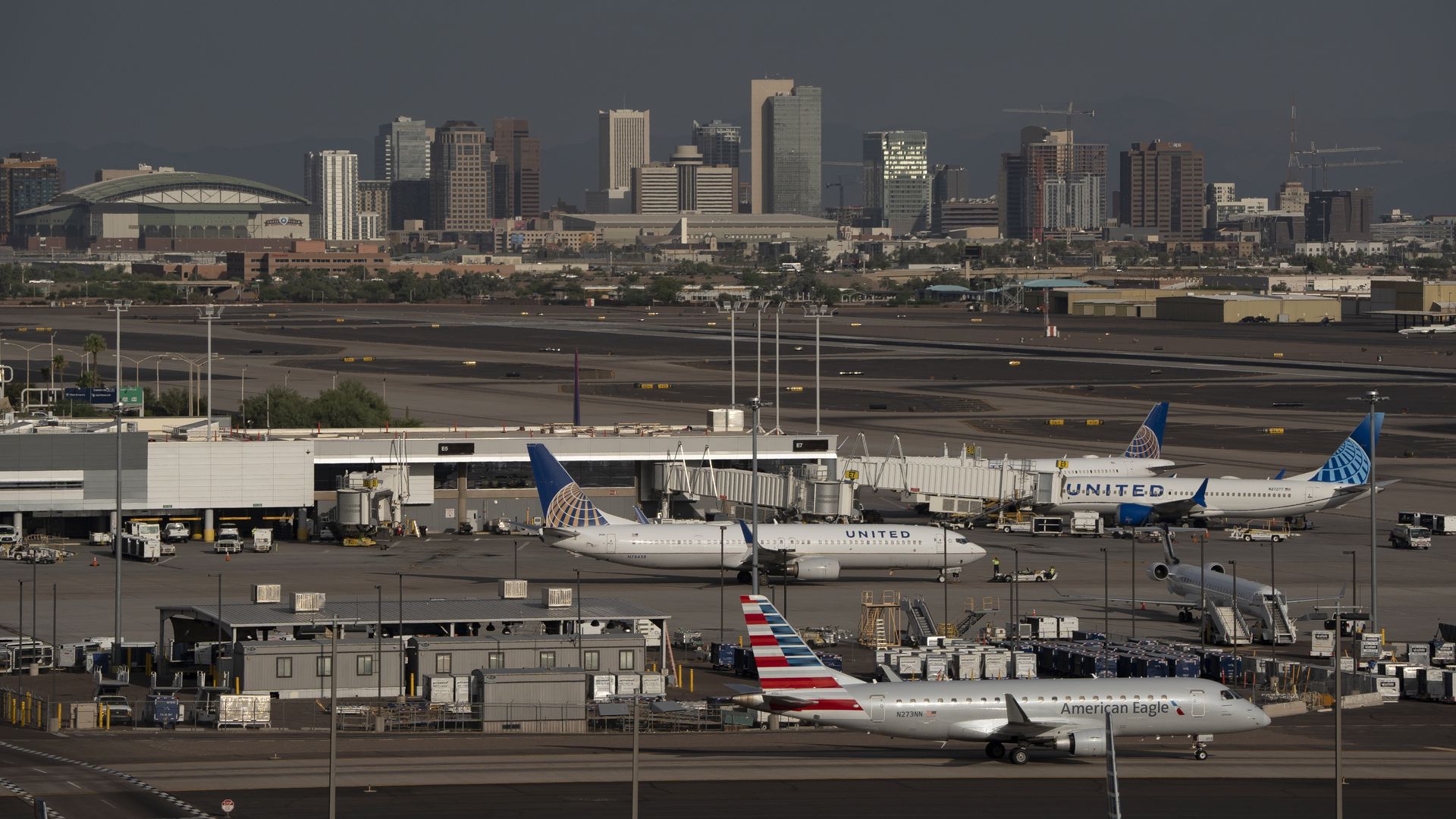 An airport with a city skyline in the background. 