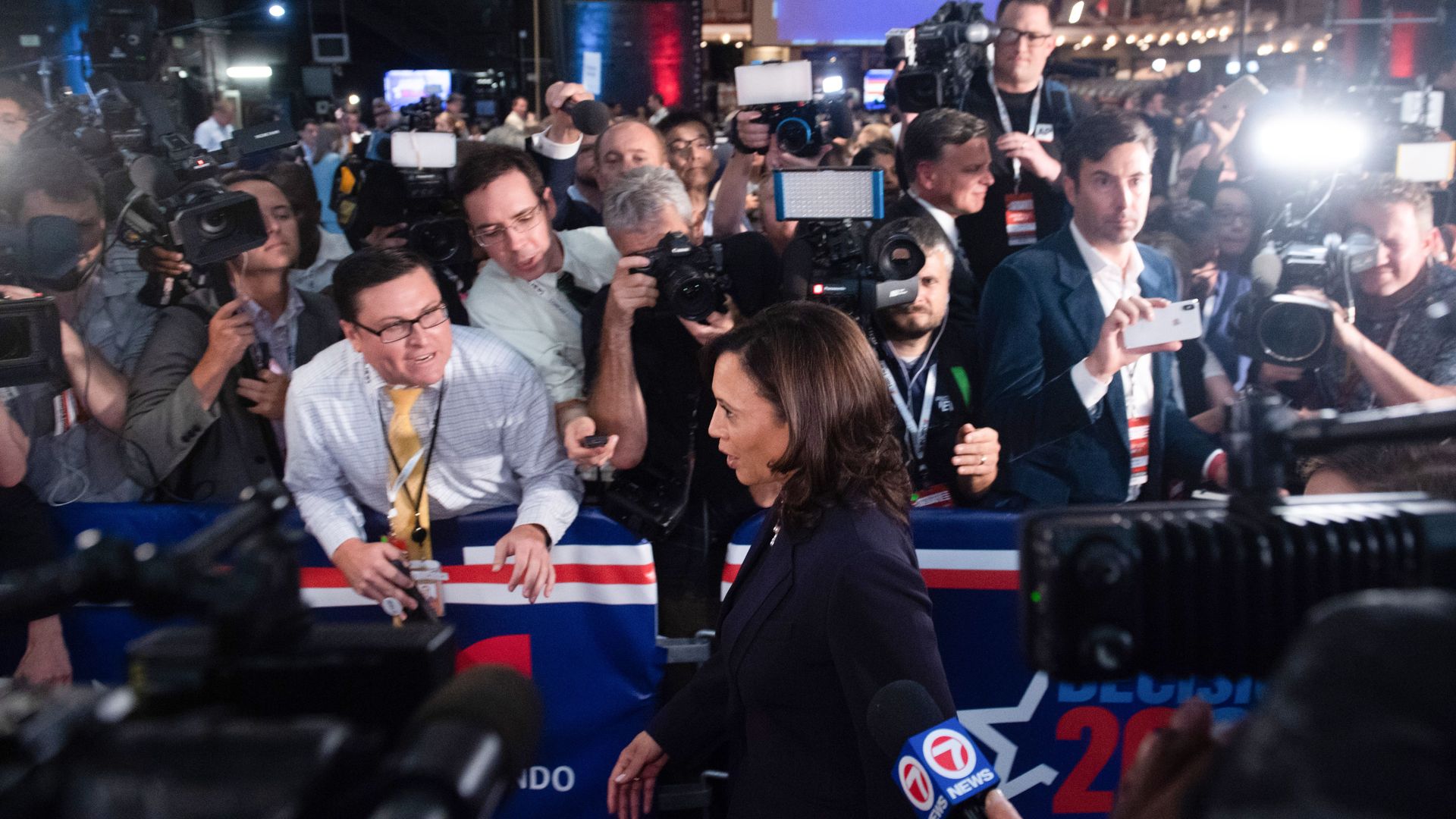 This image shows Kamala Harris waking past the media.